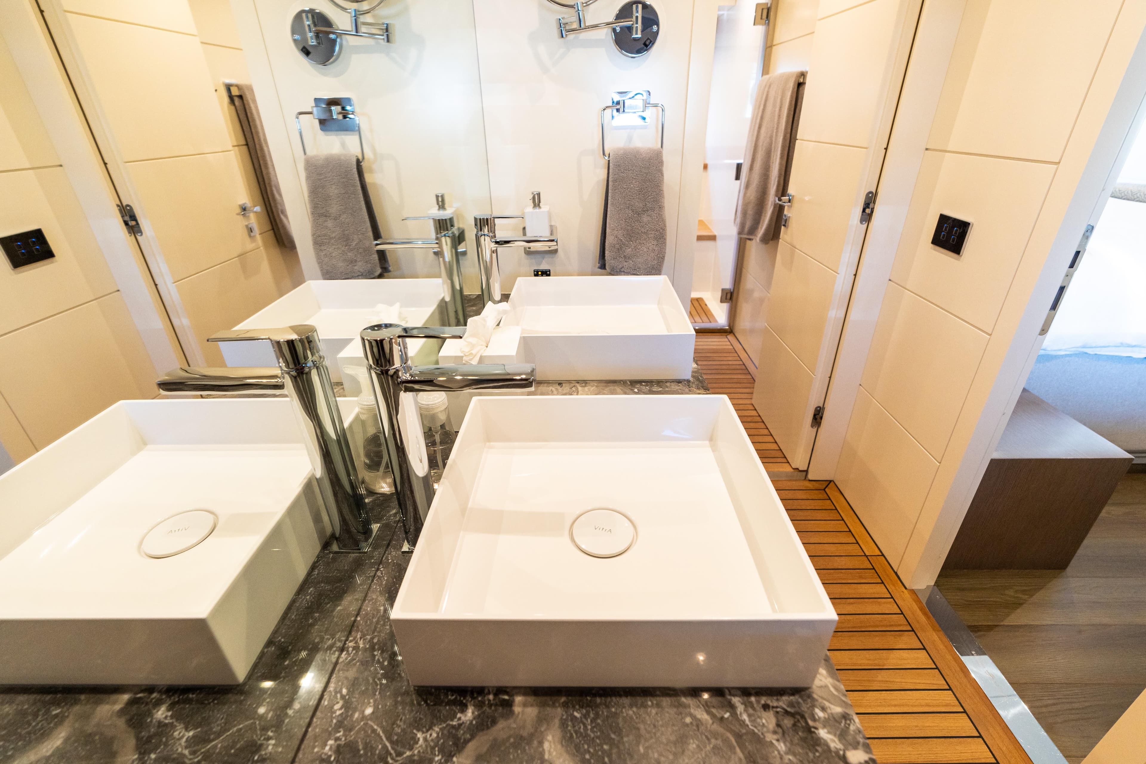 Luxurious bathroom in 2019 Sirena 64 yacht with dual sinks and elegant fixtures.