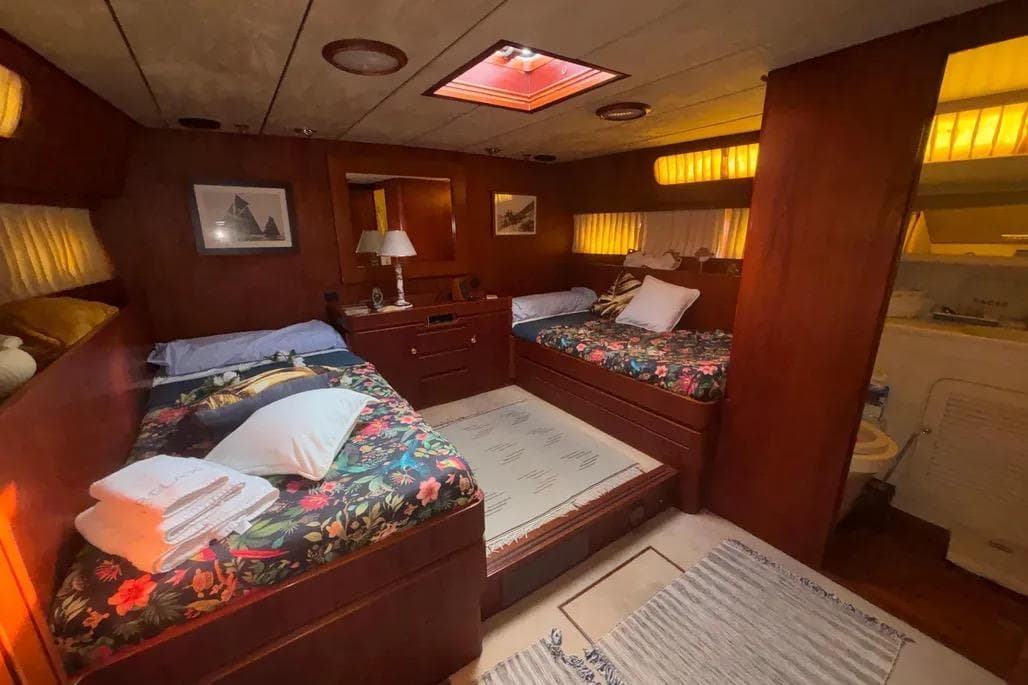 Luxurious 1988 Jongert 2000s yacht cabin with twin beds and elegant wood paneling.