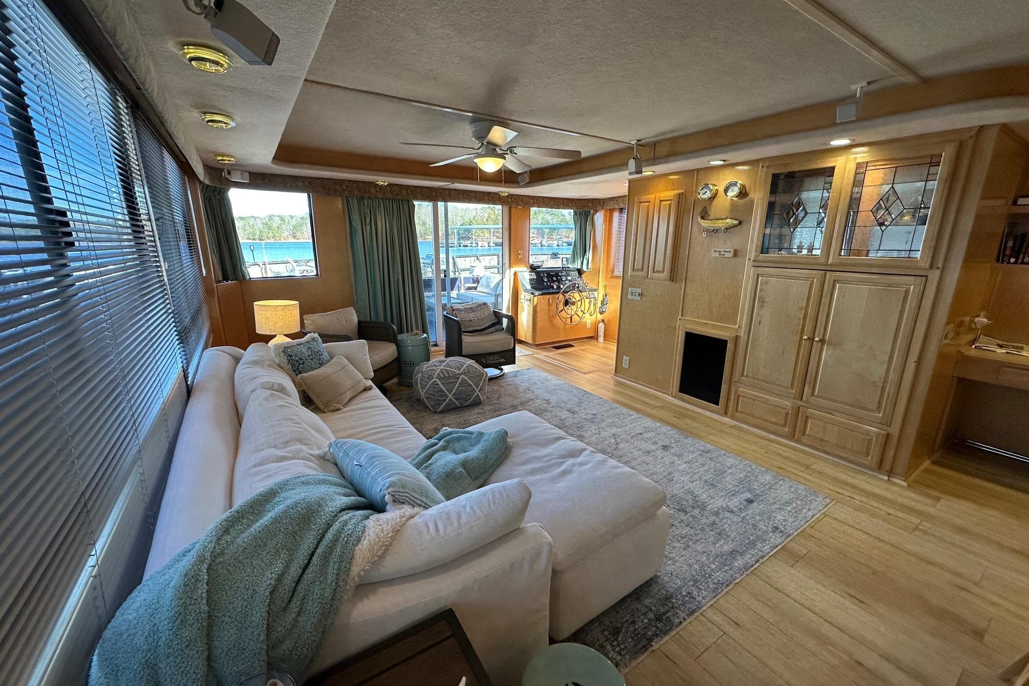 Luxurious 2000 Sumerset 16x73 houseboat interior with cozy seating and elegant wood cabinetry.