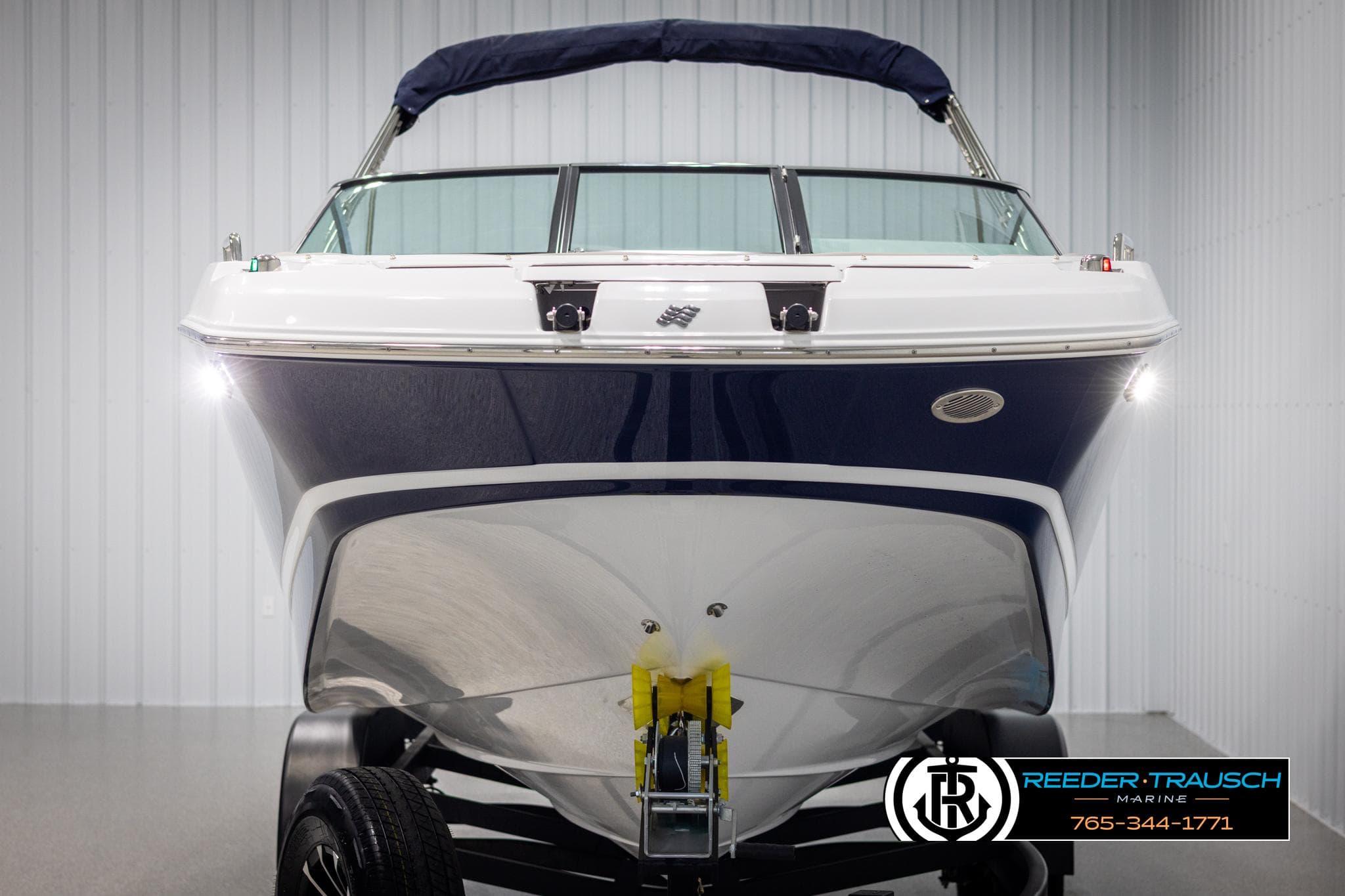 2025 Four Winns HD5 boat in showroom, front view with trailer.