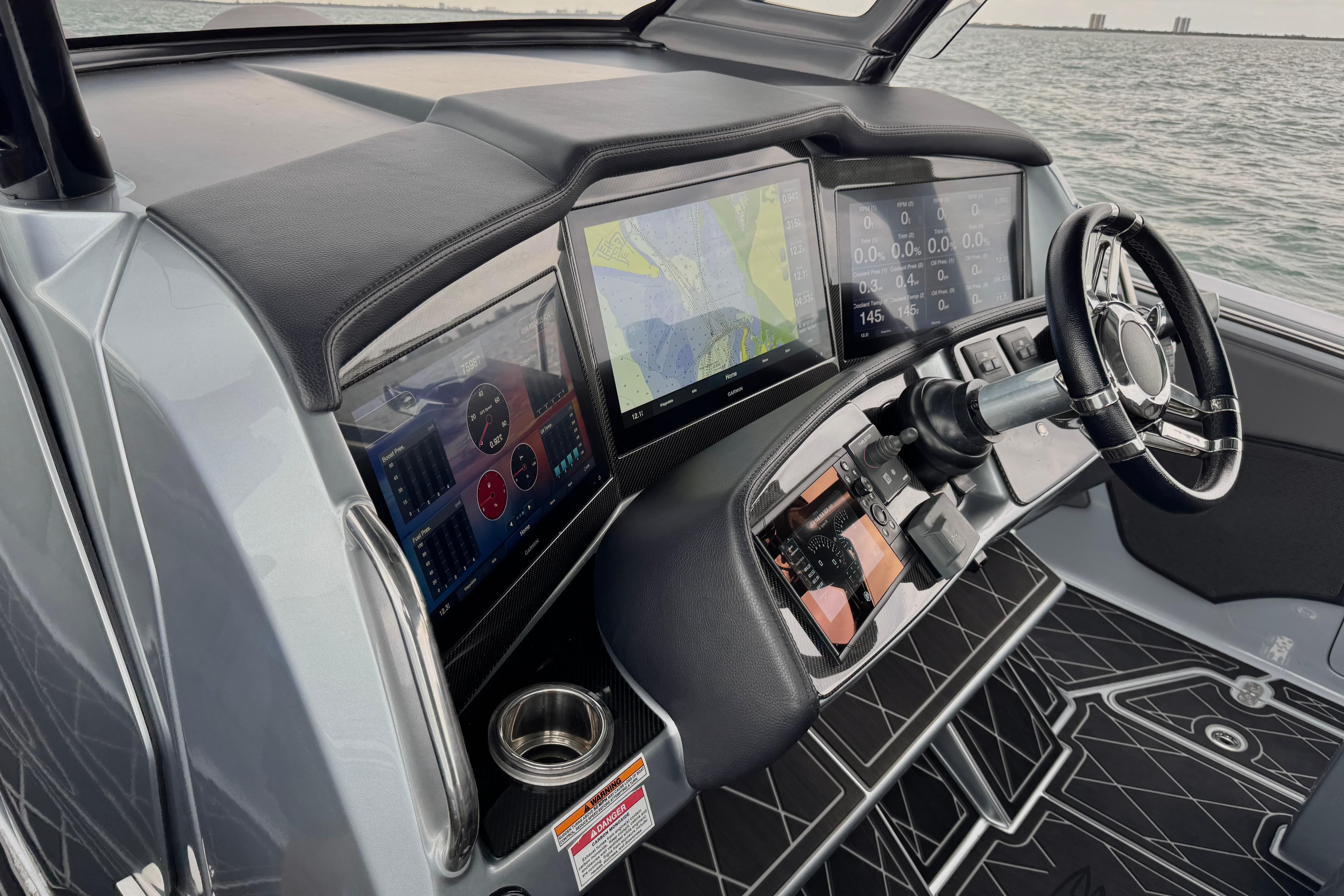 Cockpit of 2019 MTI V42 boat with advanced navigation displays and steering wheel.
