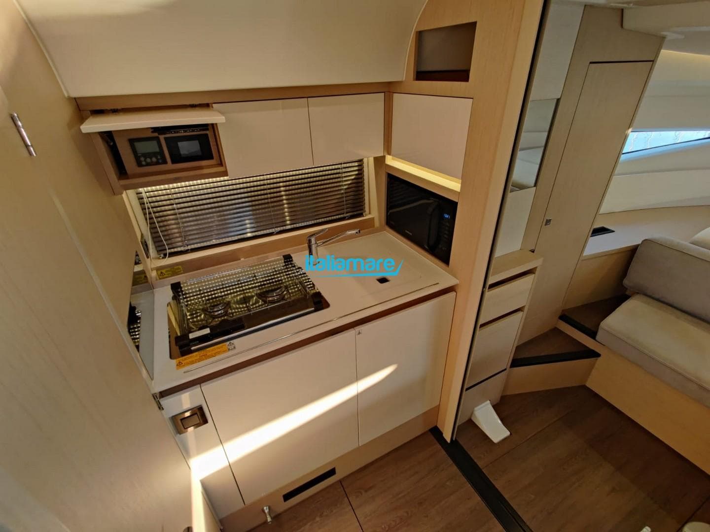 Modern kitchen area in 2020 Jeanneau Leader 36 yacht, featuring sleek cabinetry and appliances.