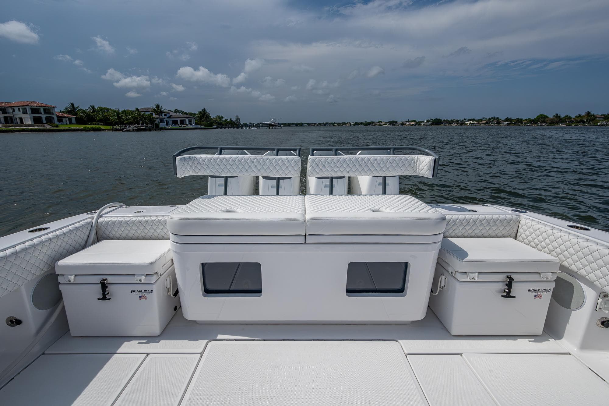 2025 HCB 48 Campeon boat deck with seating and storage, overlooking calm waters.