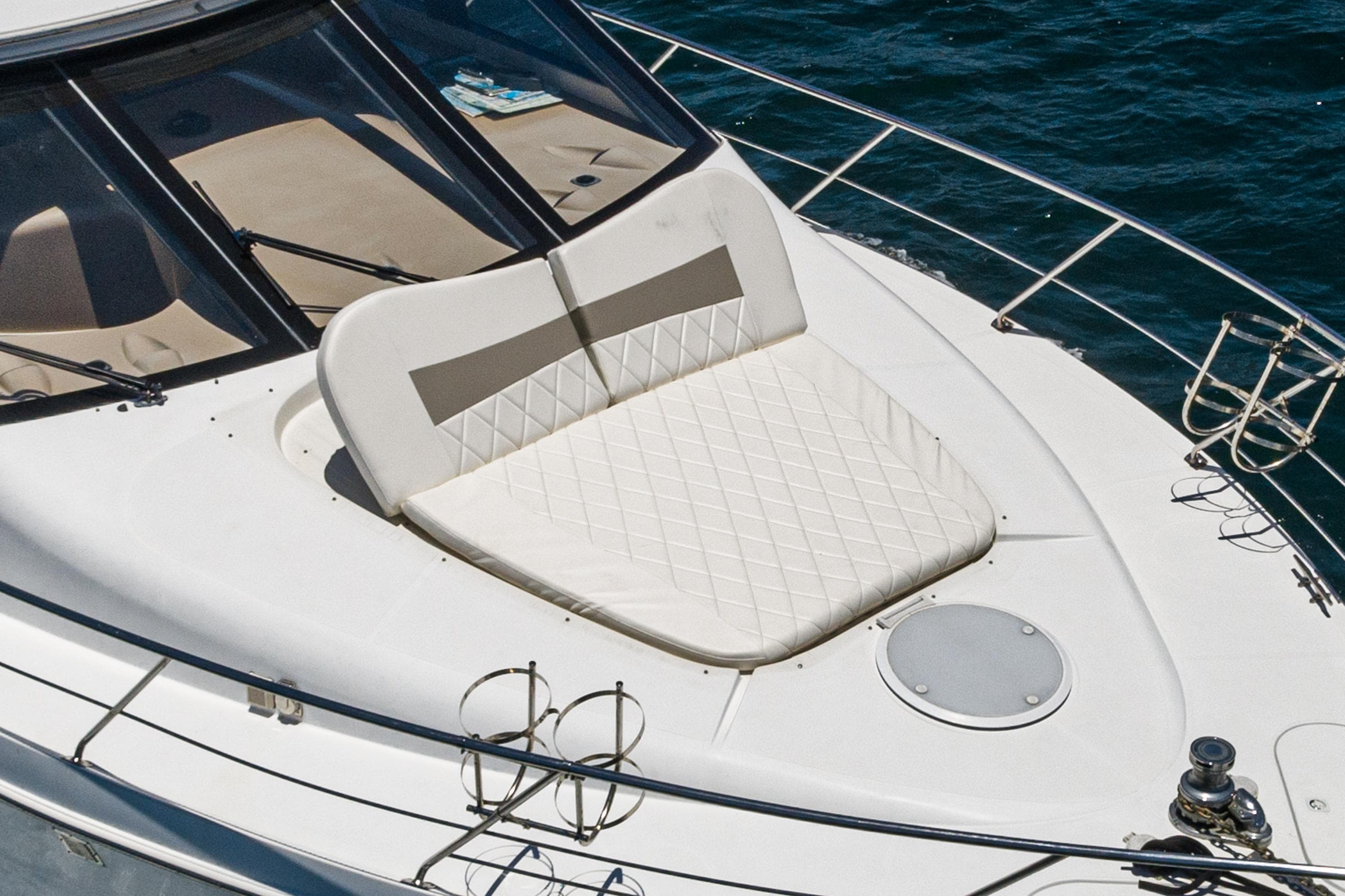 1999 Carver 530 Voyager Pilothouse yacht with cushioned sun deck on calm water.