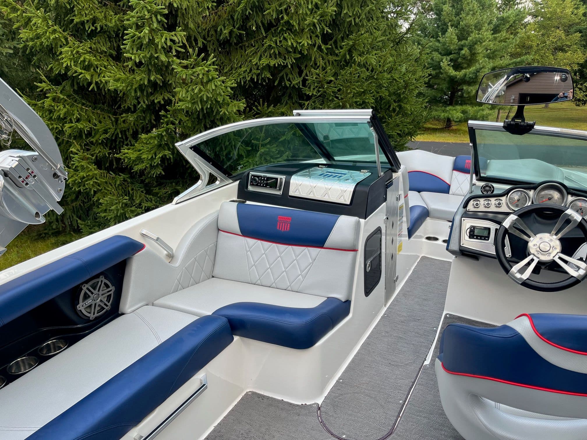 Interior of a 2015 MasterCraft X20 boat with blue and white seating.