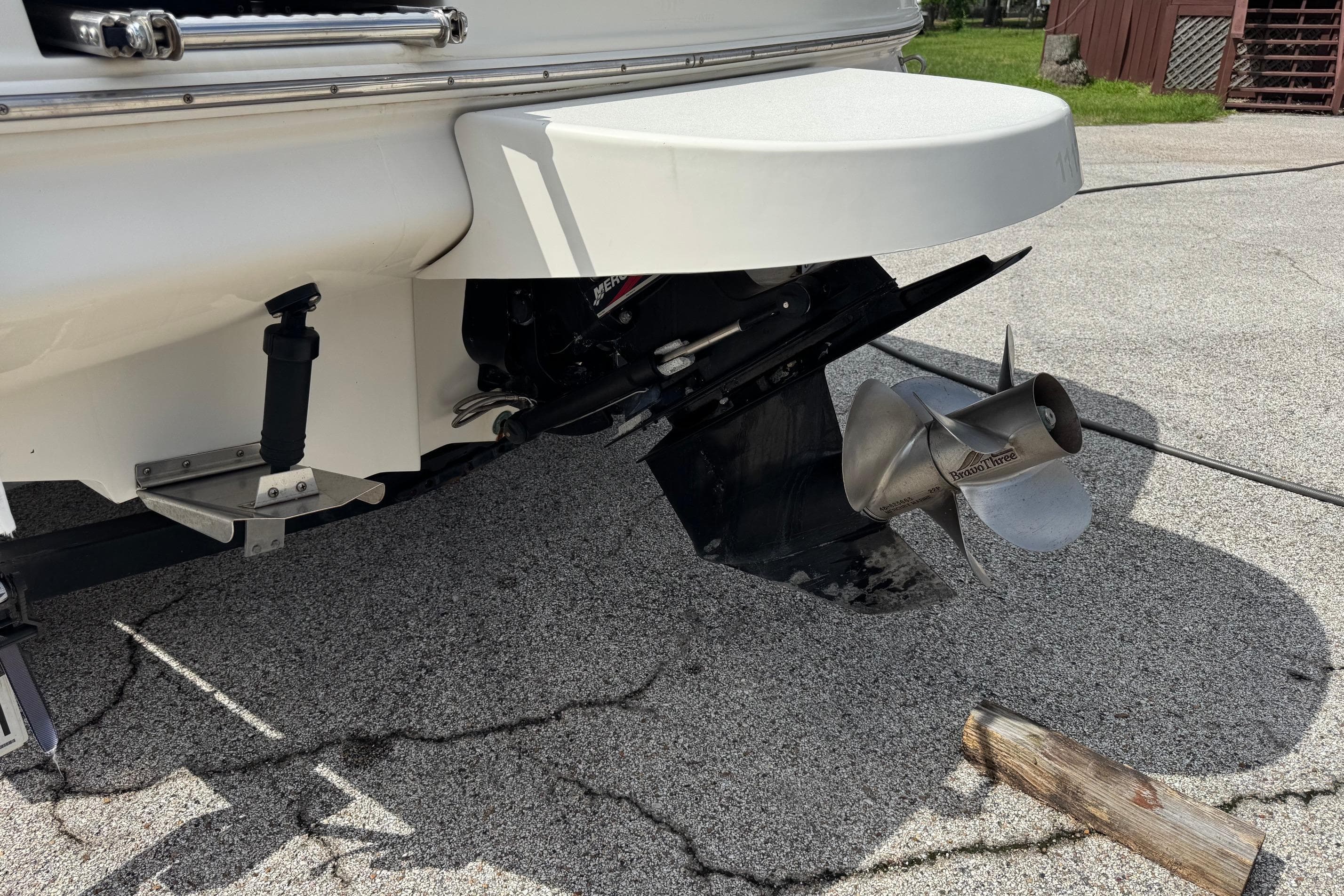 Rear view of a 2001 Sea Ray 210 Bow Rider boat with propeller and trim tabs.