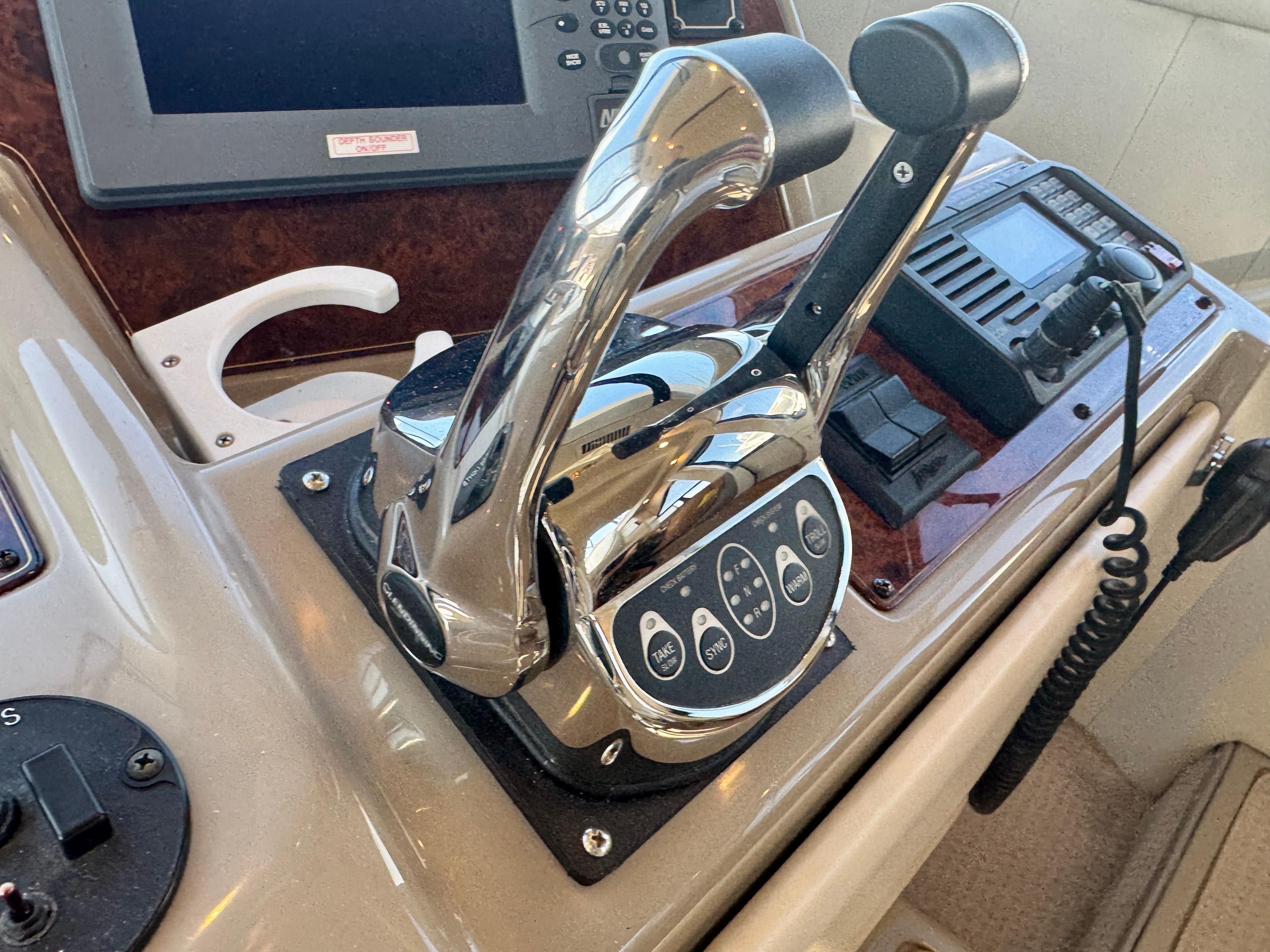 Control panel of a 1999 Bayliner 5288 Pilot House Motoryacht with chrome throttle levers.