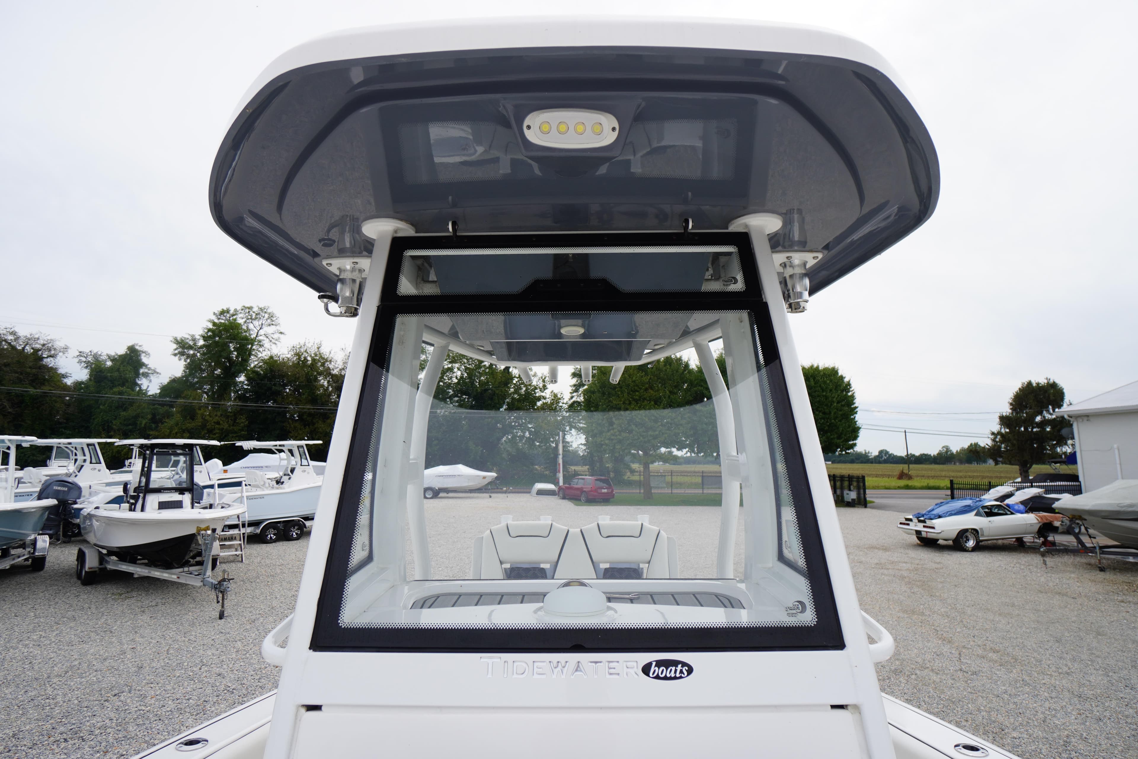 2021 Tidewater 256 CC Adventure boat, front view, in a marina setting.
