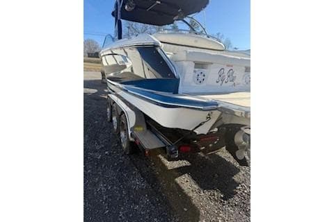 2018 Cobalt A28 boat on trailer, rear view, parked outdoors.