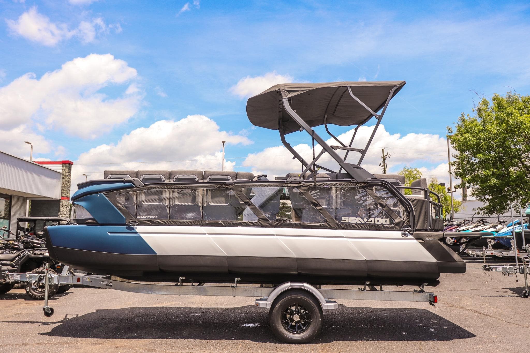 2026 Sea-Doo Switch Cruise 21 pontoon boat on trailer under blue sky.