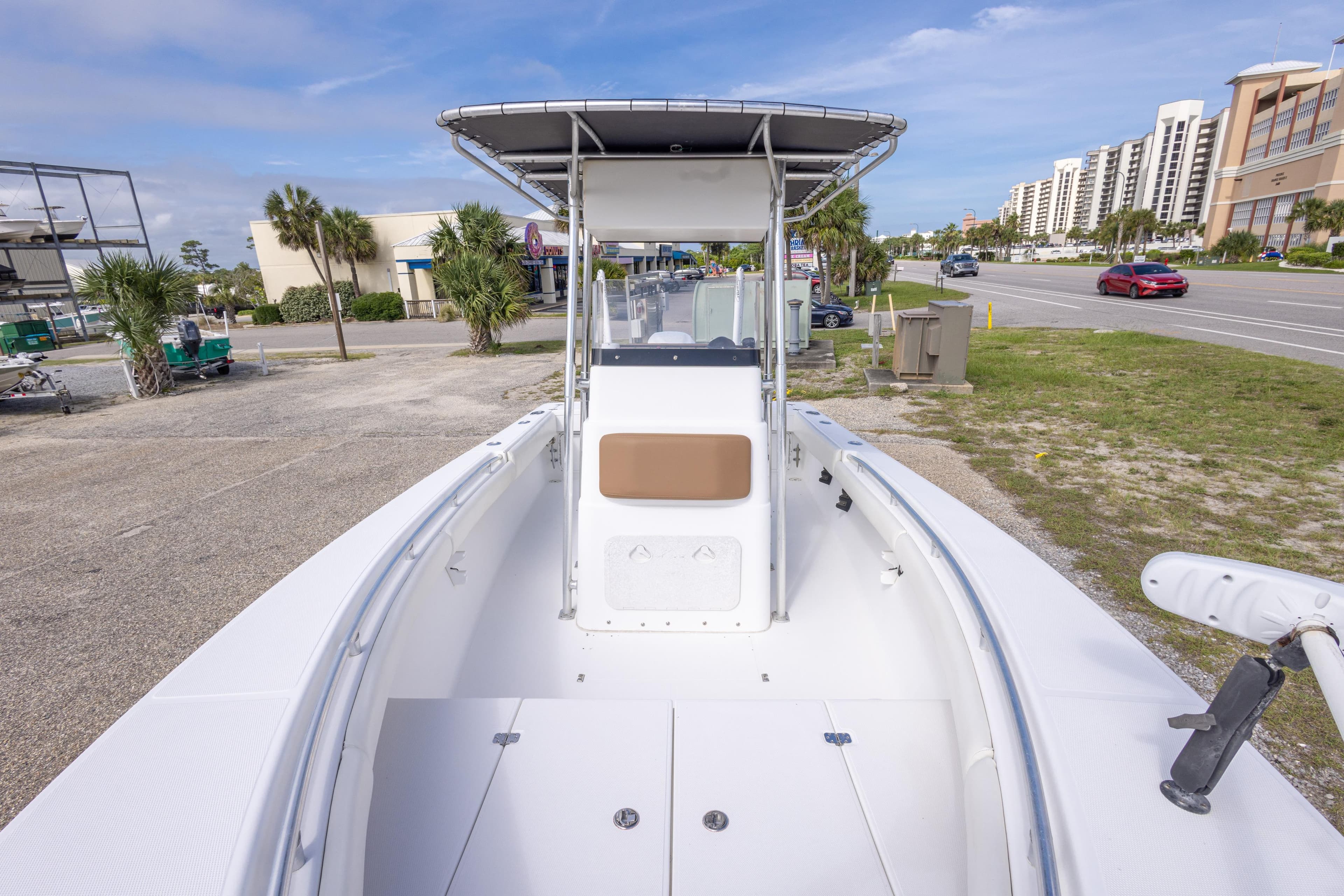 2004 Sea Craft 23 CC boat with center console, parked near a road and buildings.