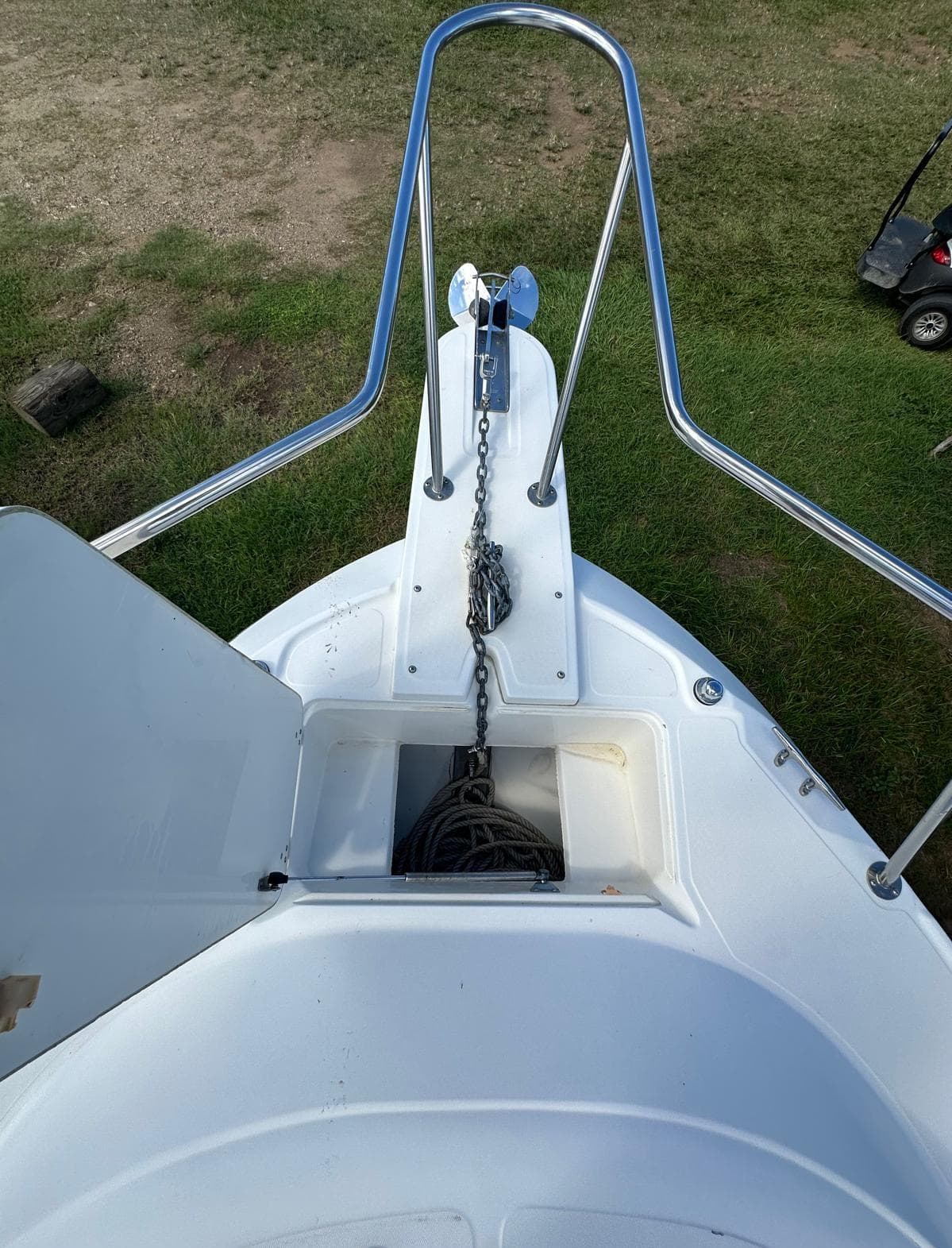 1998 Boston Whaler 23 Conquest bow with anchor chain and storage compartment.
