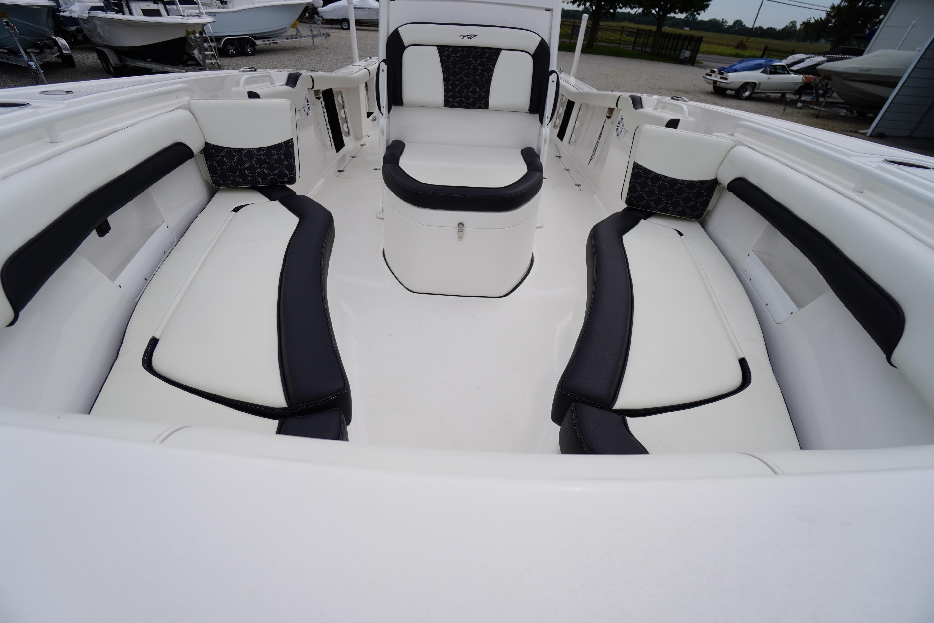 2021 Tidewater 256 CC Adventure boat interior with cushioned seating and storage.