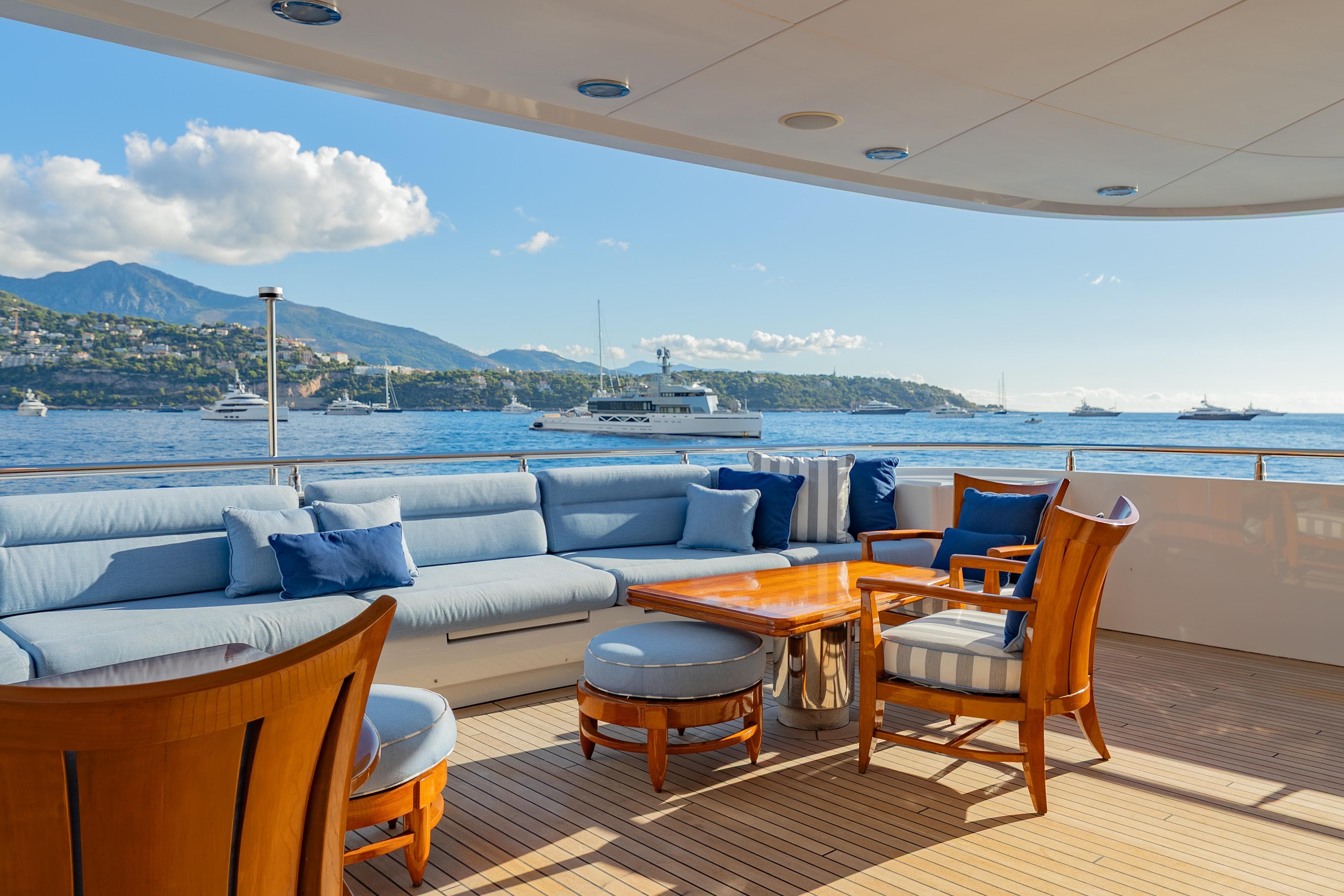 Luxurious deck of 2009 Timmerman Expedition Tri-Deck yacht with ocean view and seating.