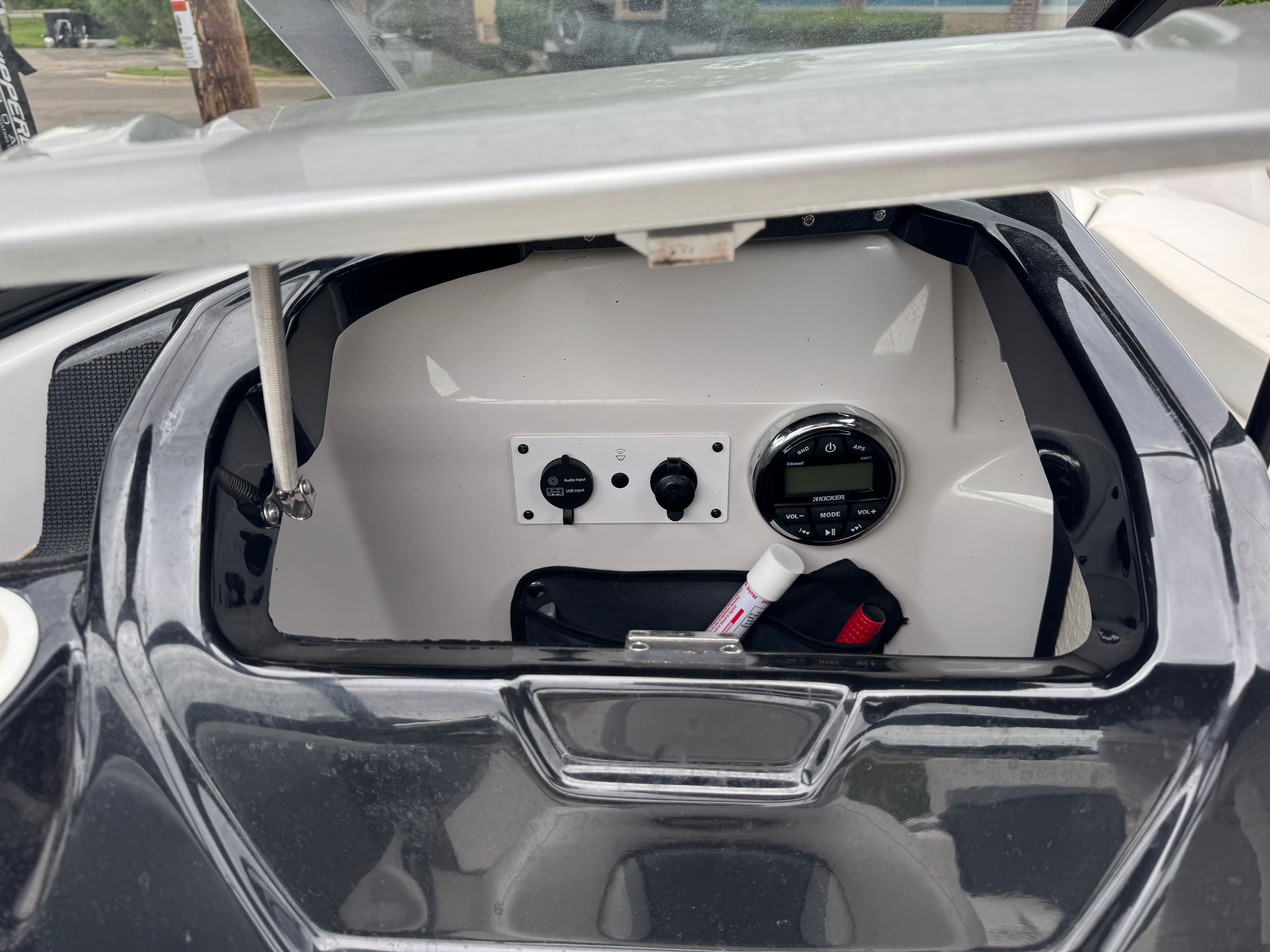 2017 Scarab SB 195 JET boat control panel with open compartment.