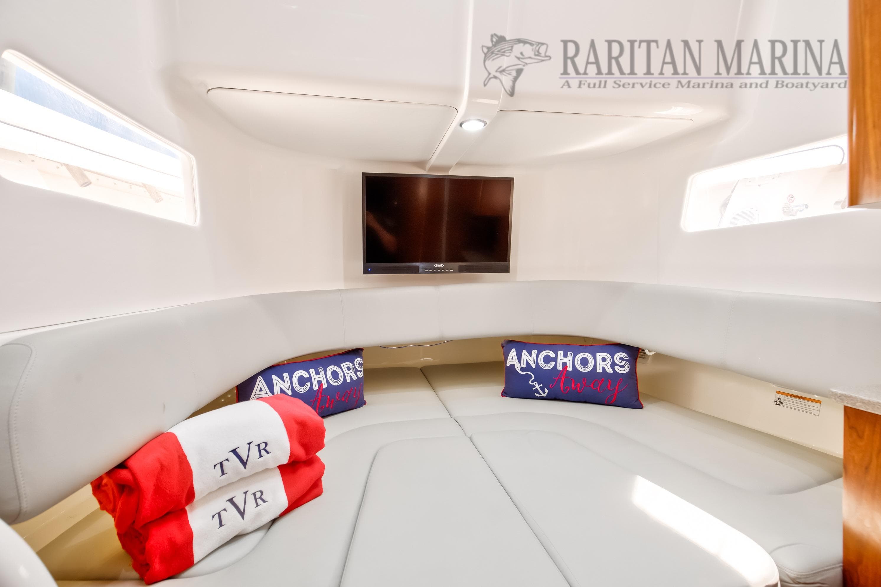 Luxurious interior of 2016 Regulator 41 boat with cozy seating and TV.