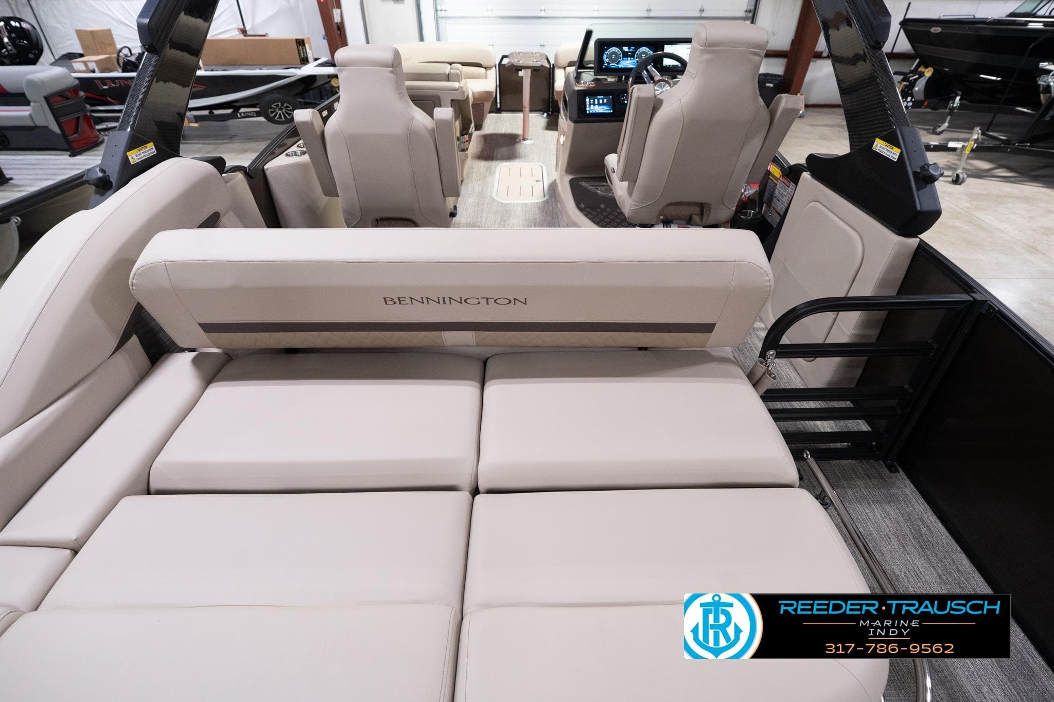 2026 Bennington 24 MSB pontoon boat interior with beige seating and modern dashboard.
