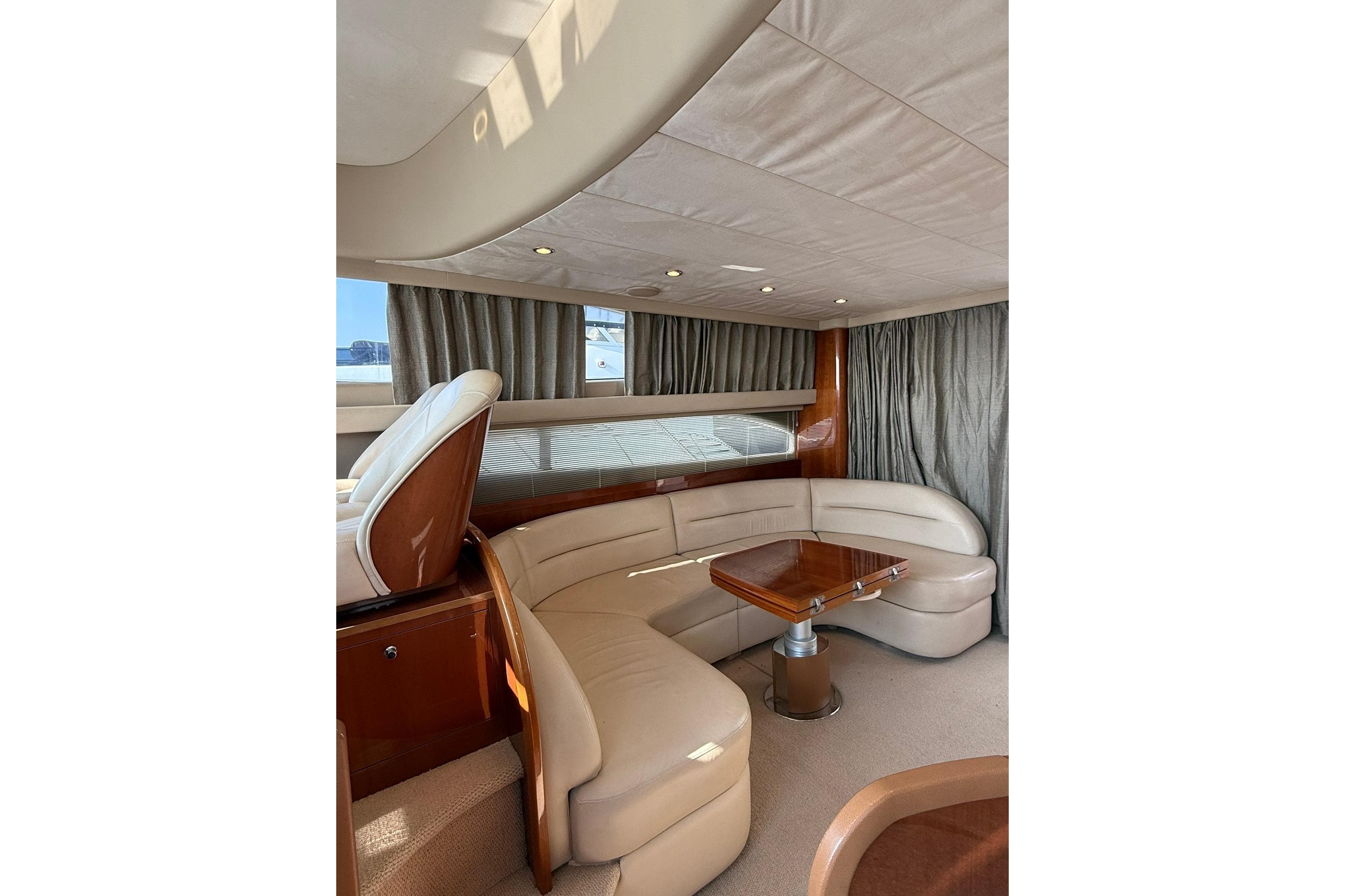 Luxurious interior of a 2007 Princess 50 yacht with elegant seating and wooden table.