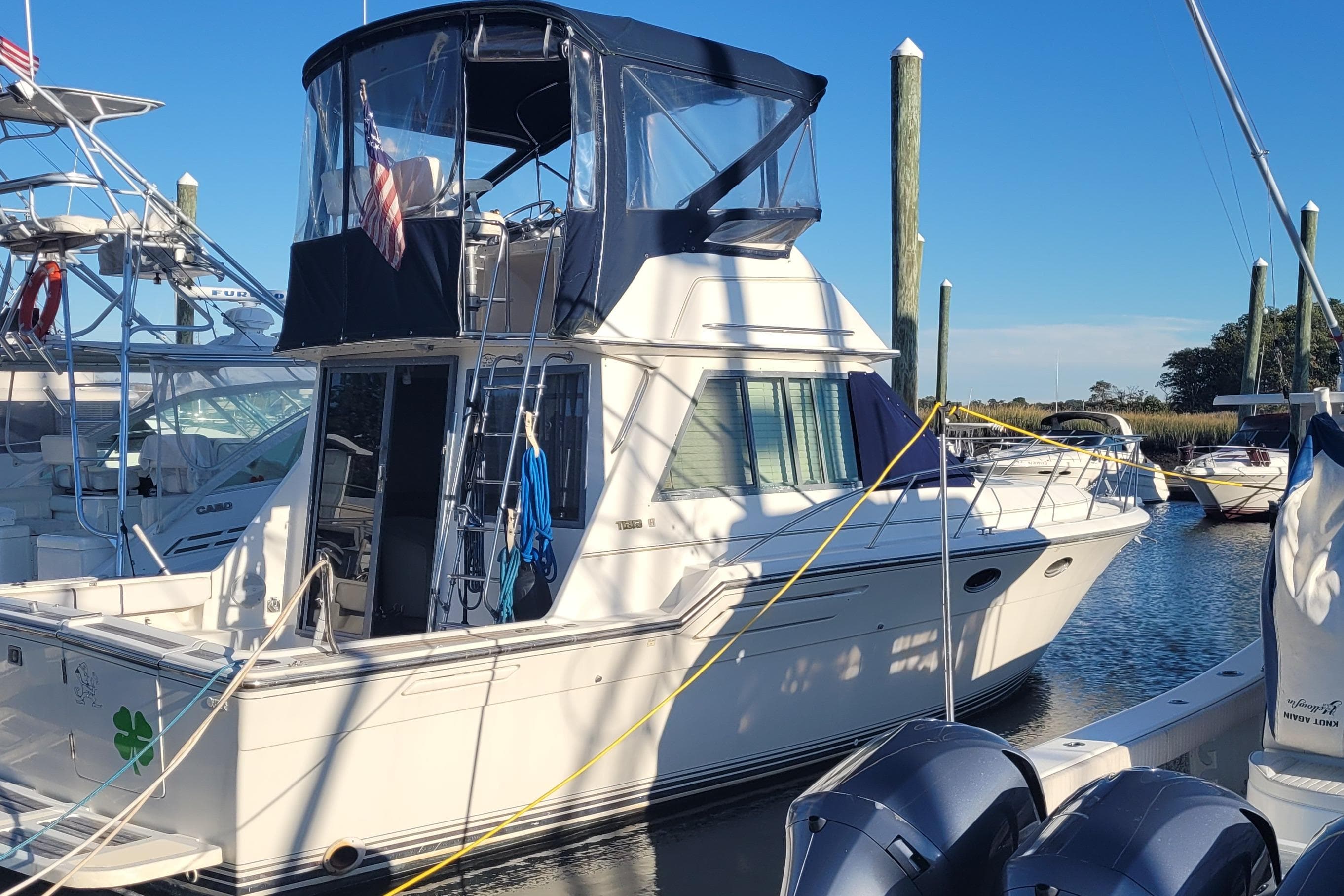 1988 Tiara Yachts 3600 Convertible docked at marina under clear blue sky.