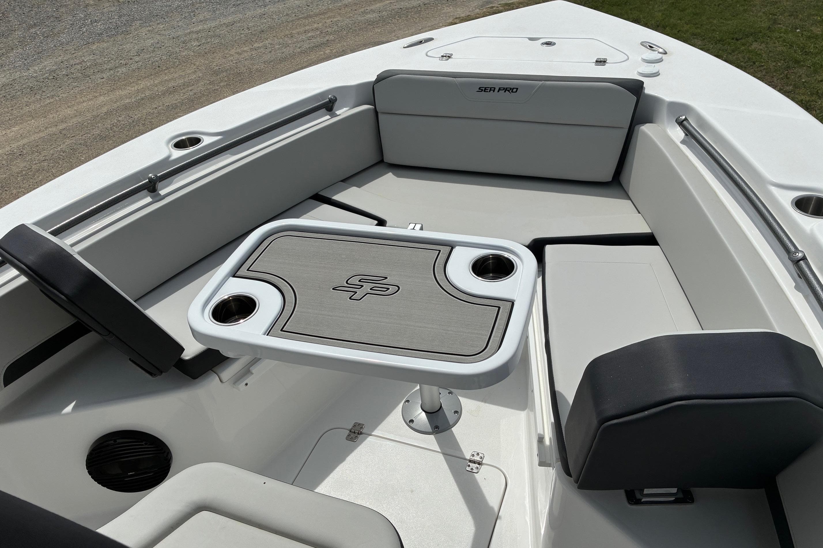 2026 Sea Pro 245FLX Sandbar boat interior with seating and table.