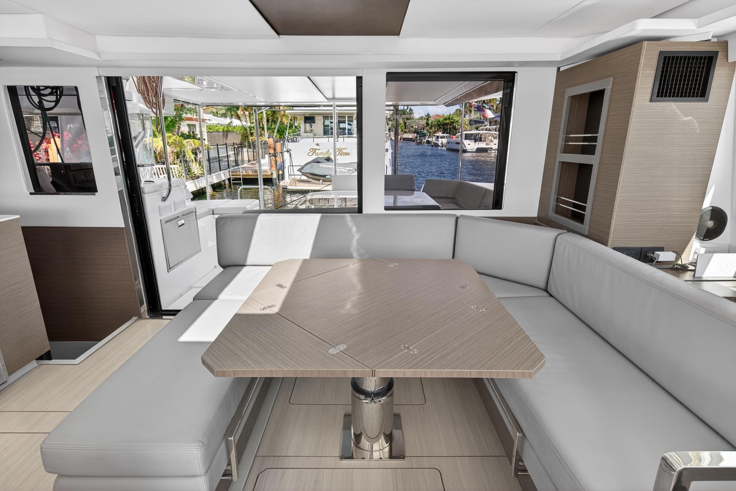 Luxurious interior of 2022 Leopard 50 yacht with modern seating and waterfront view.