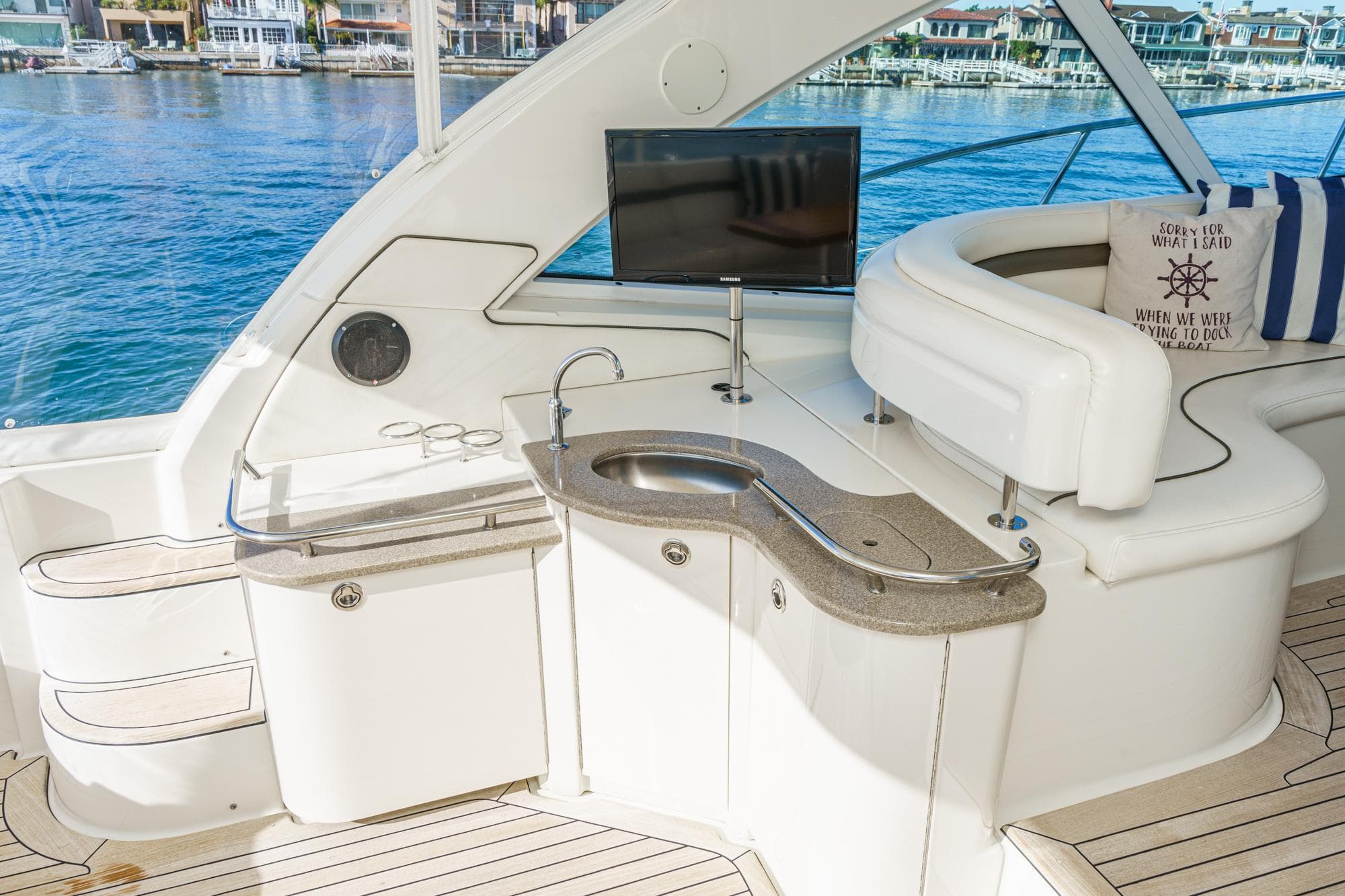 Luxurious interior of 2005 Sea Ray 480 Sundancer with bar and TV.