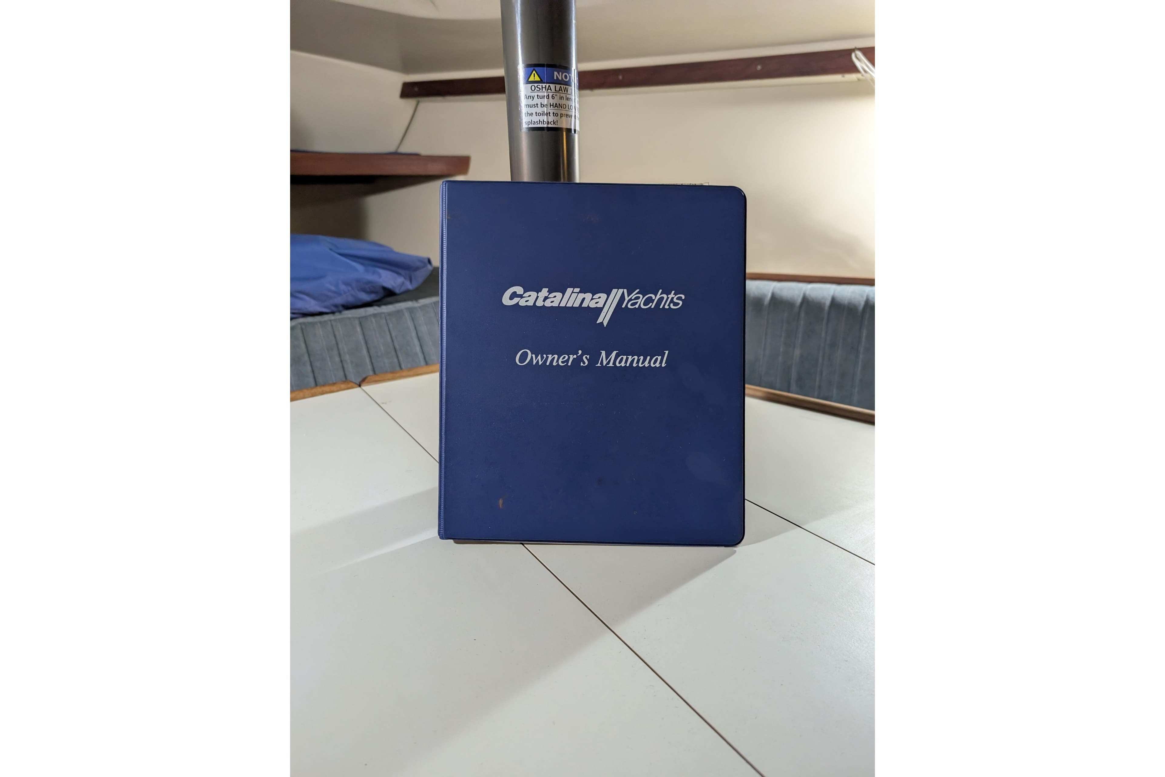 Catalina Capri 26 owner's manual on a yacht table, 1990 model.