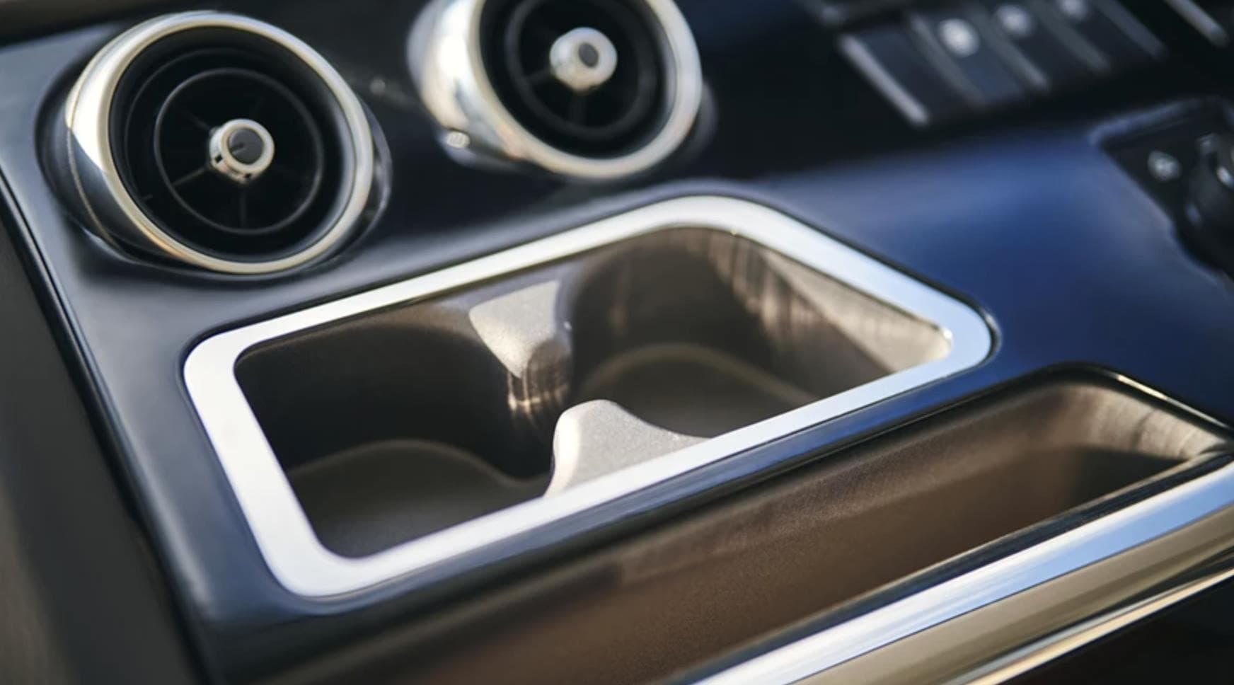 2025 Princess F65 interior, featuring sleek cup holders and modern air vents.