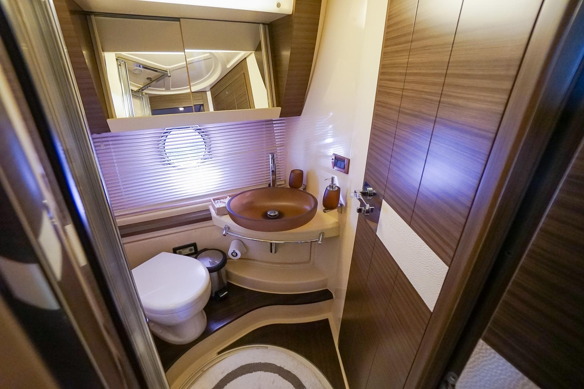 Luxurious bathroom in 2014 Azimut 54 Flybridge yacht with modern fixtures and wood accents.