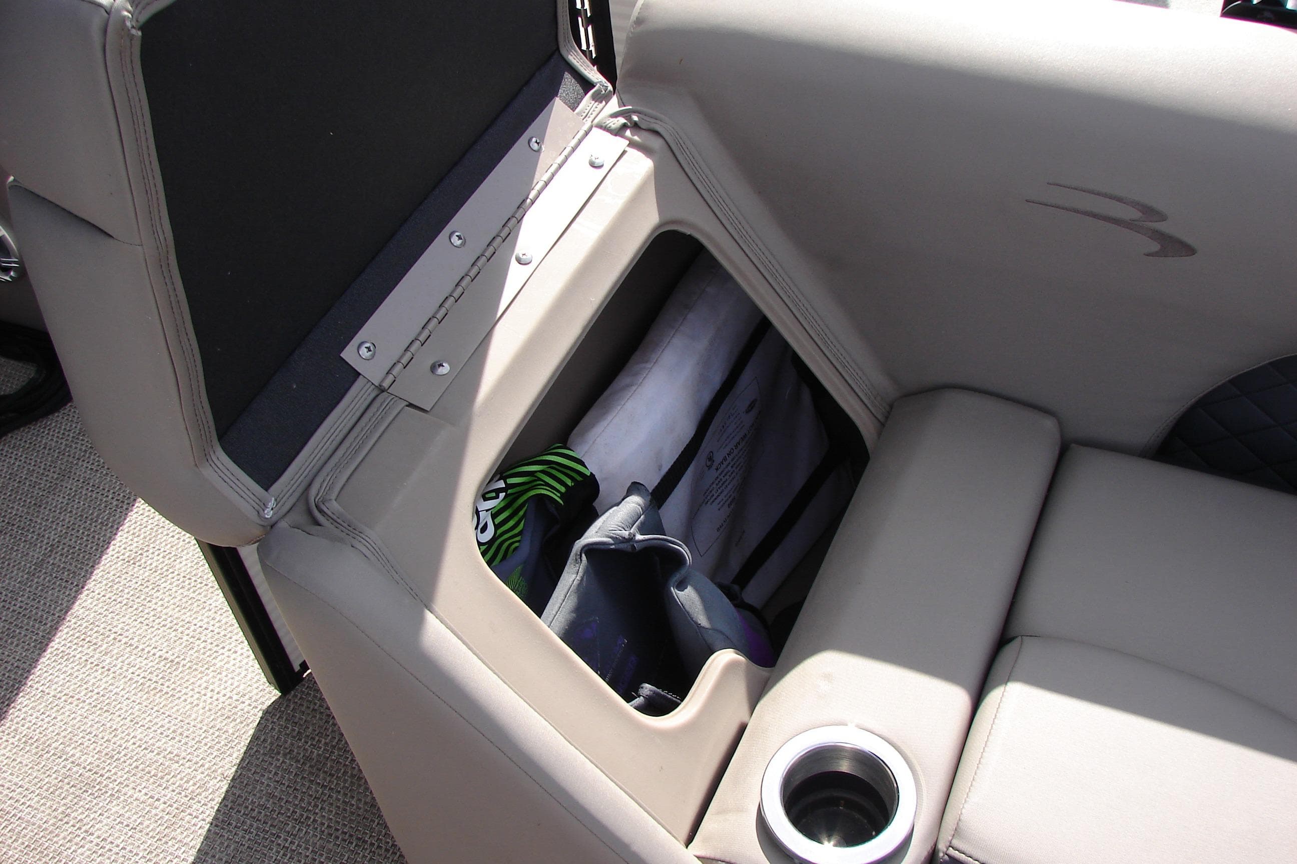 2019 Bennington SX 25 SCWXP boat seat storage with cup holder and gear.