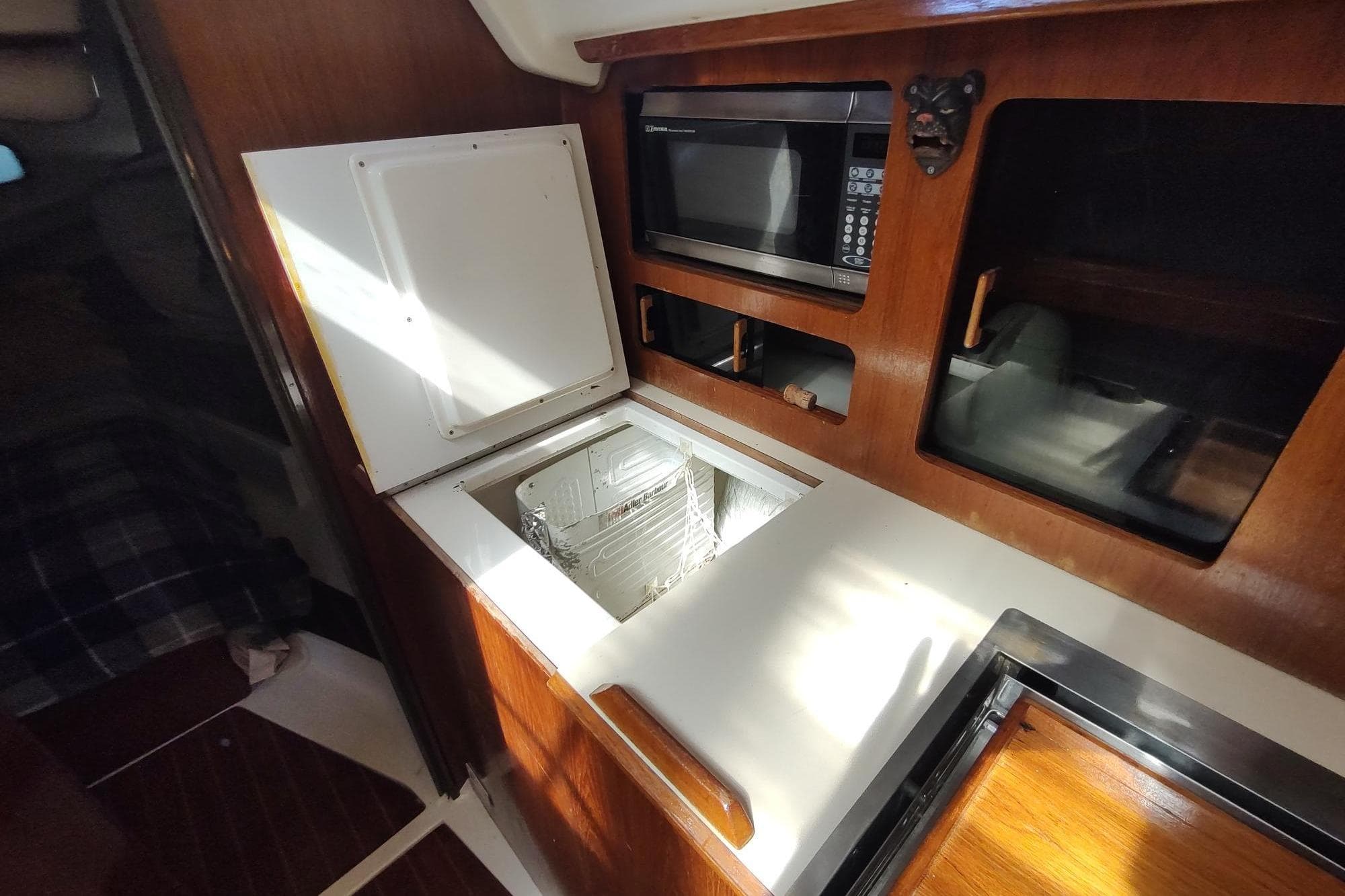Interior of 1987 Hunter 37 Legend yacht with microwave and storage compartments.