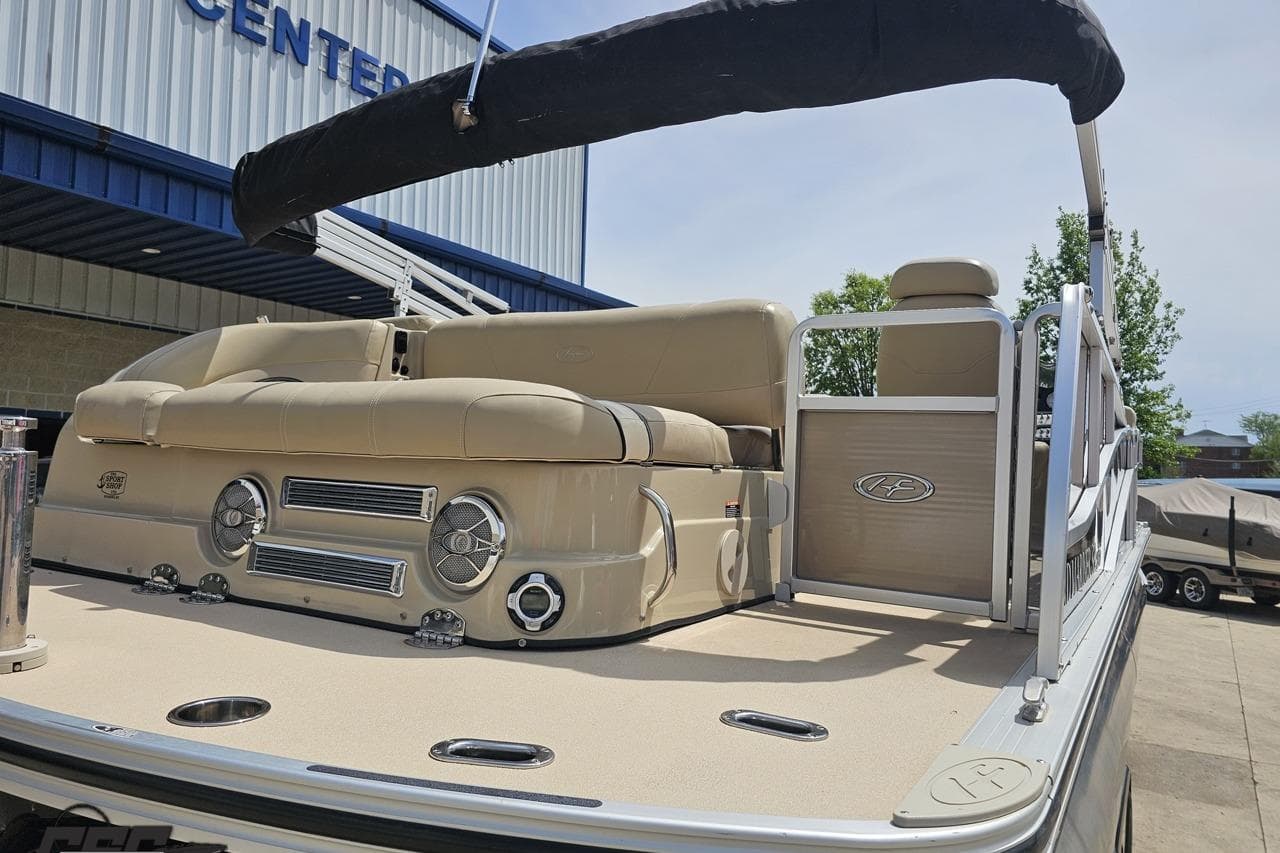 2012 Harris FloteBote 230 Grand Mariner SEL pontoon boat with beige seating and canopy.