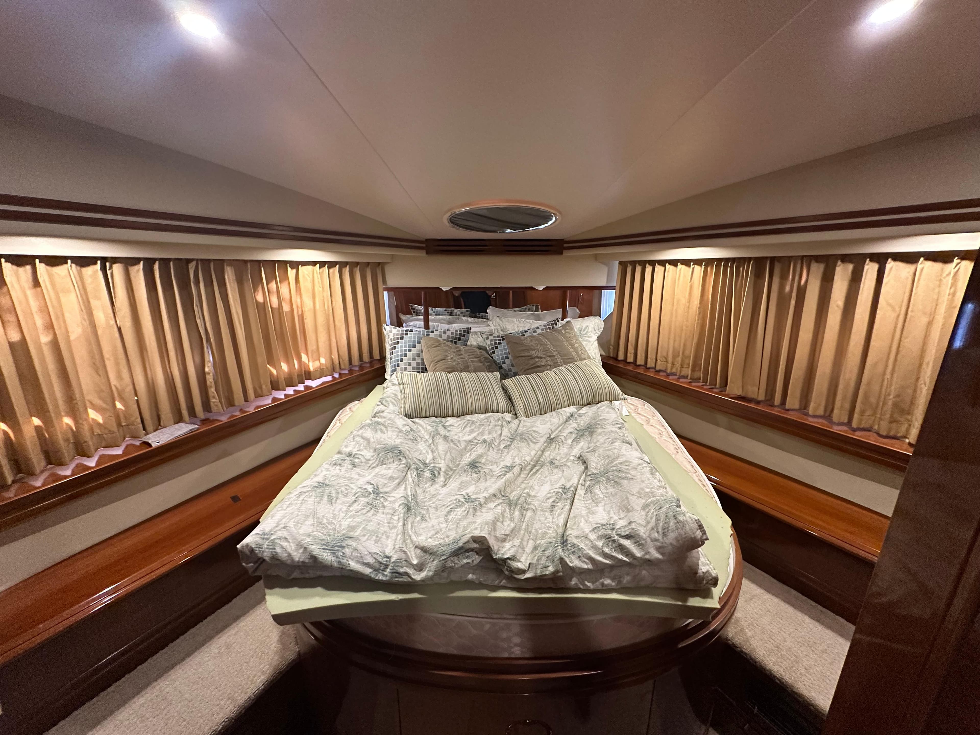 Luxurious bedroom interior of 2005 Carver 56 Voyager yacht with elegant bedding.