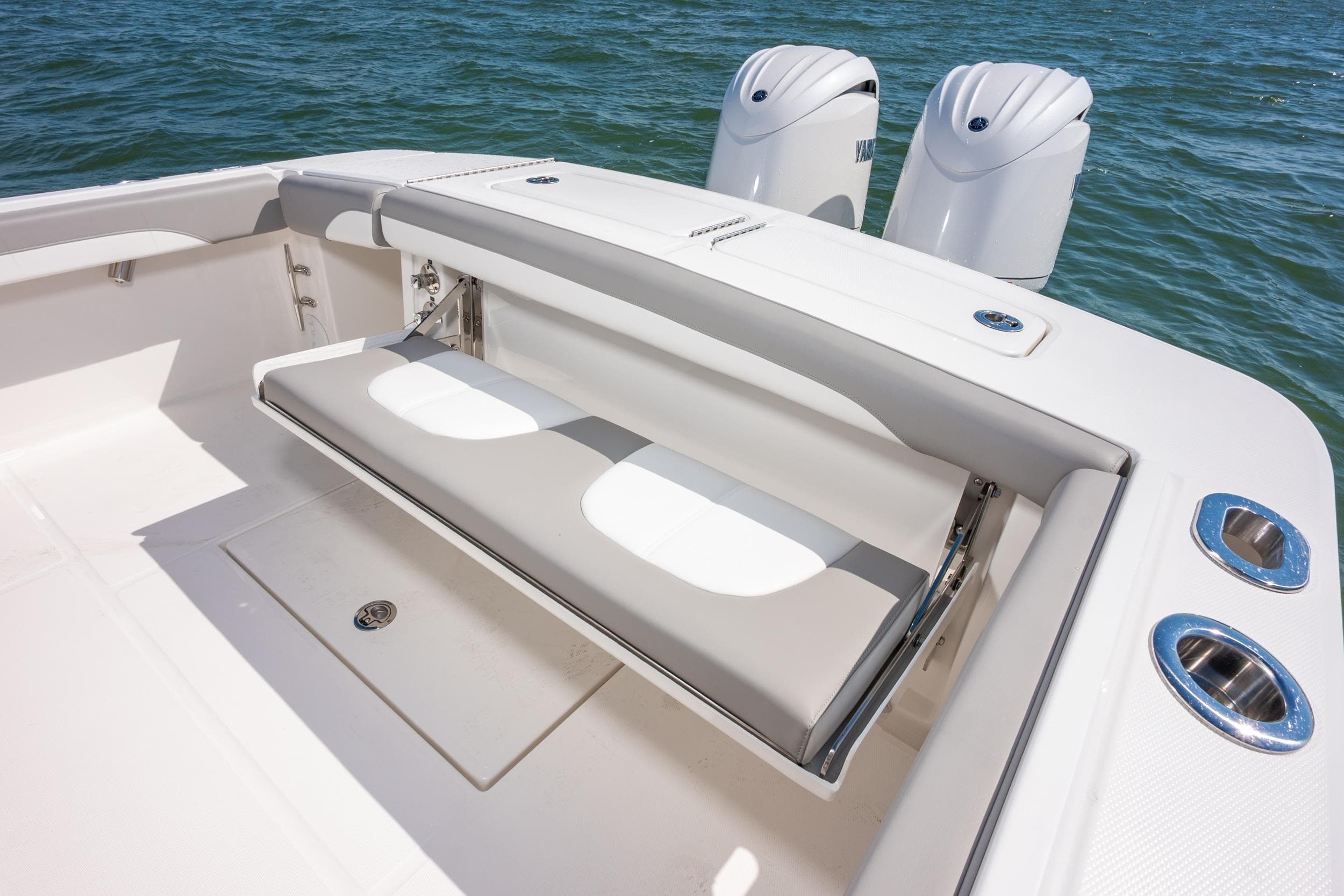 2026 Regulator 23 boat with foldable seating and dual outboard motors on the water.