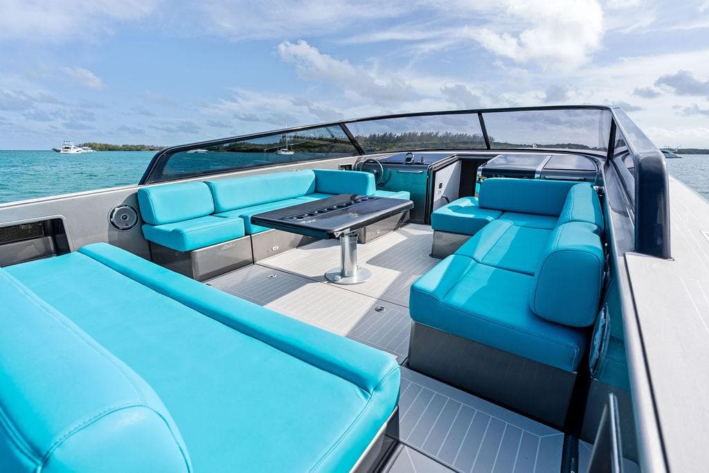 Luxurious 2015 VanDutch 55 yacht with turquoise seating and sleek design on open water.