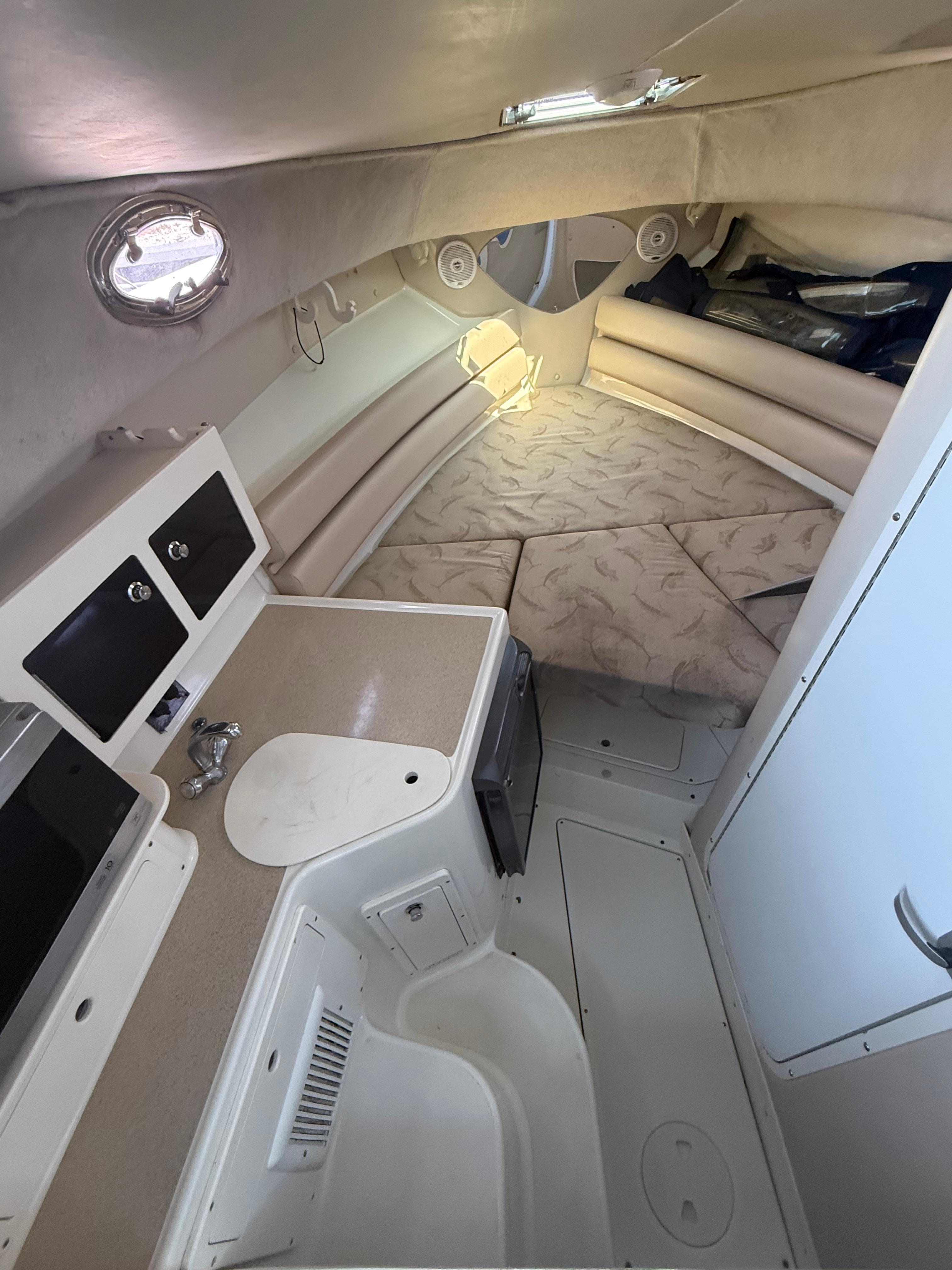 2003 Hydra-Sports Vector 2800 WA cabin interior with seating and kitchenette.
