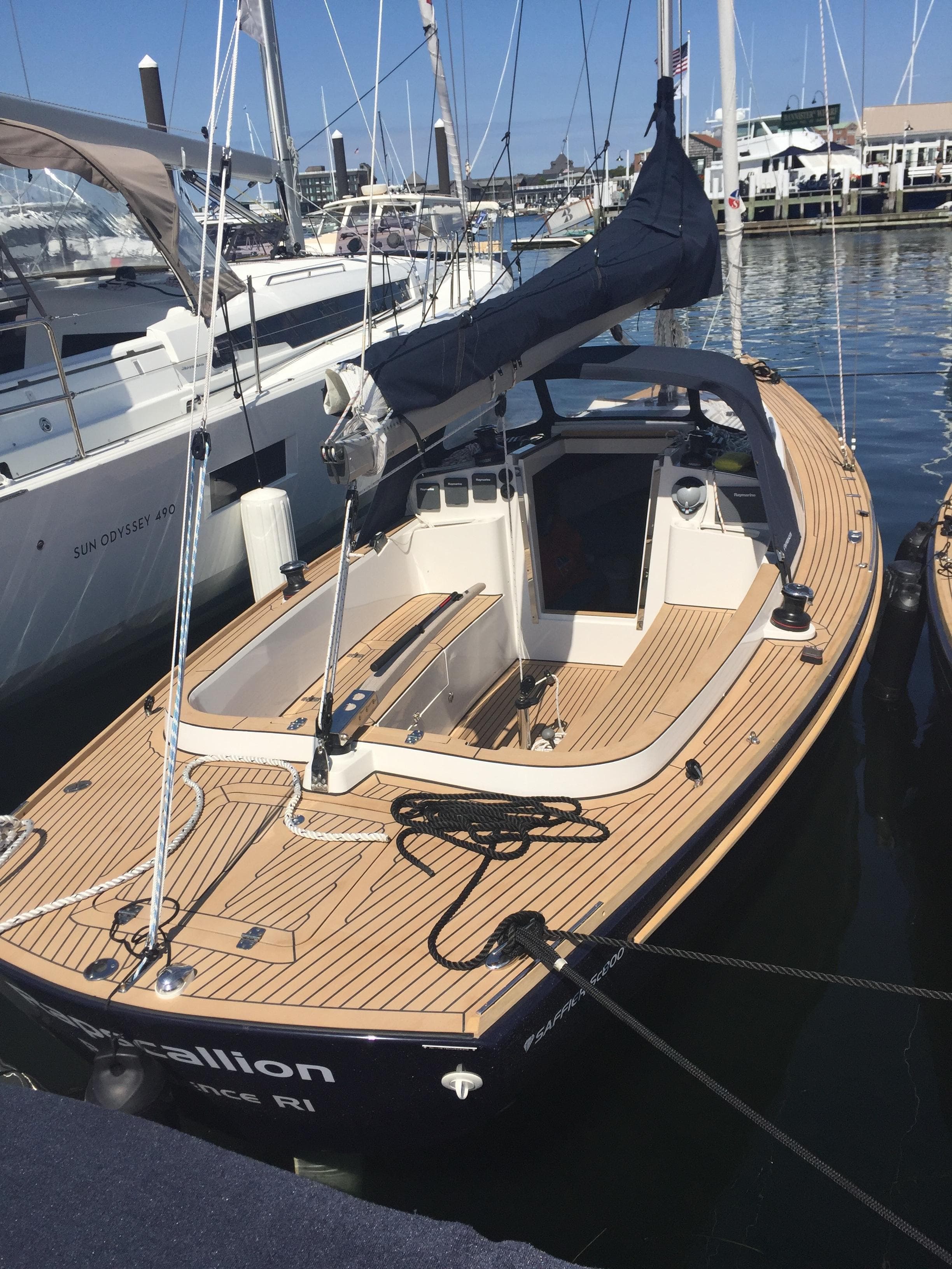 2025 Saffier SC 8M Cabin sailboat docked in a marina, featuring sleek design and wooden deck.