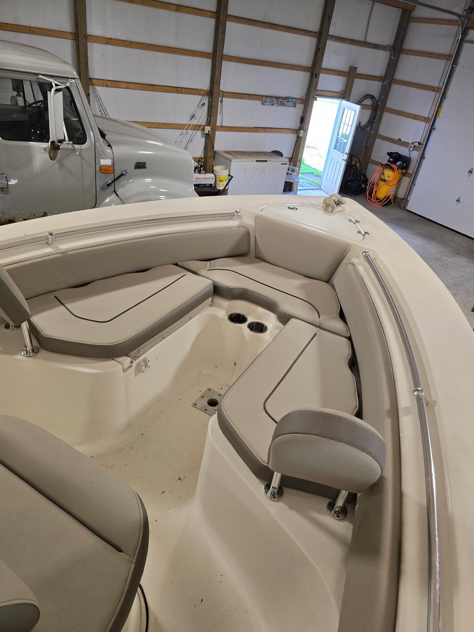 2023 Key West 219 FS boat interior with cushioned seating in a garage.