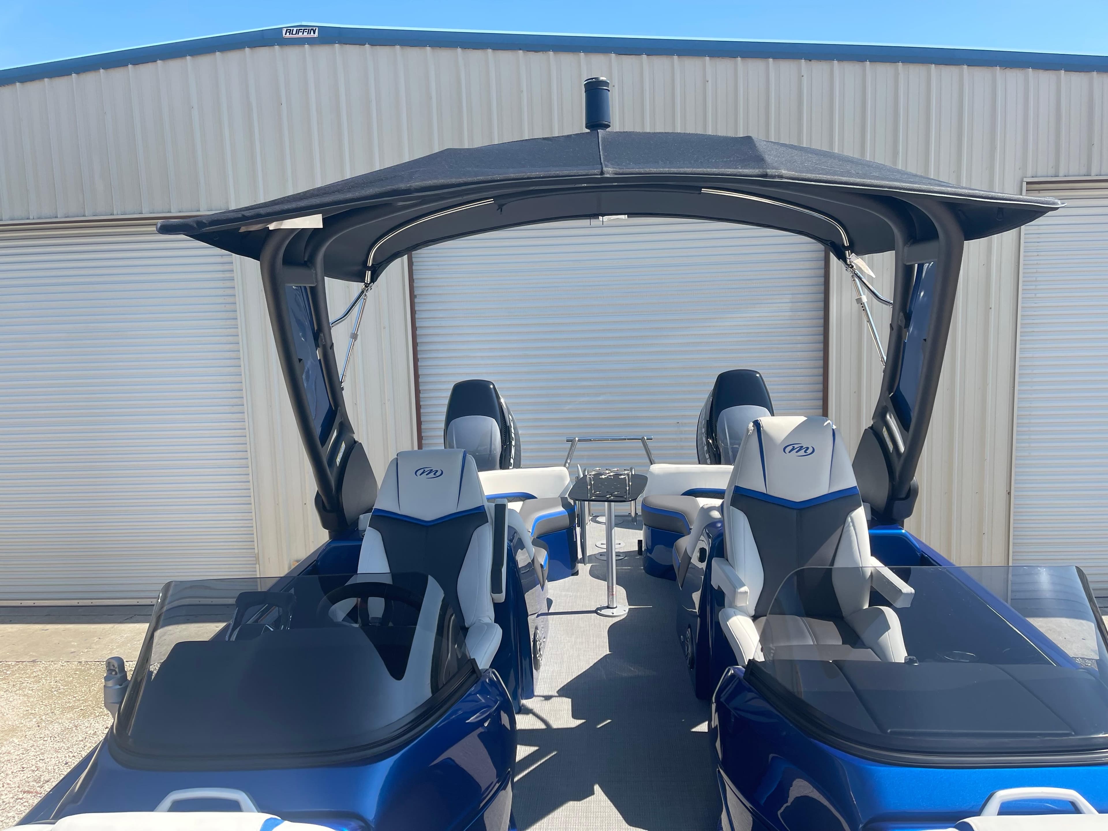2024 Manitou 25 XT SHP DE pontoon boat with canopy and seating.
