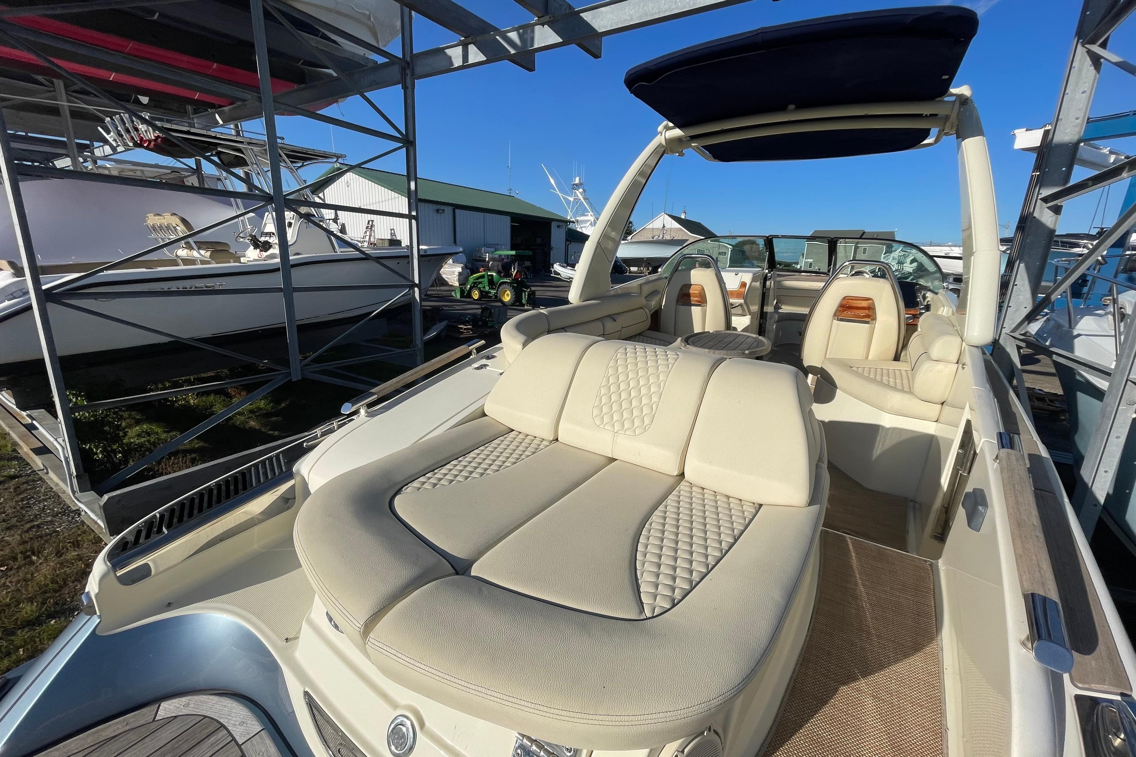 2020 Chris-Craft Launch 28 GT boat with luxurious seating in a marina setting.
