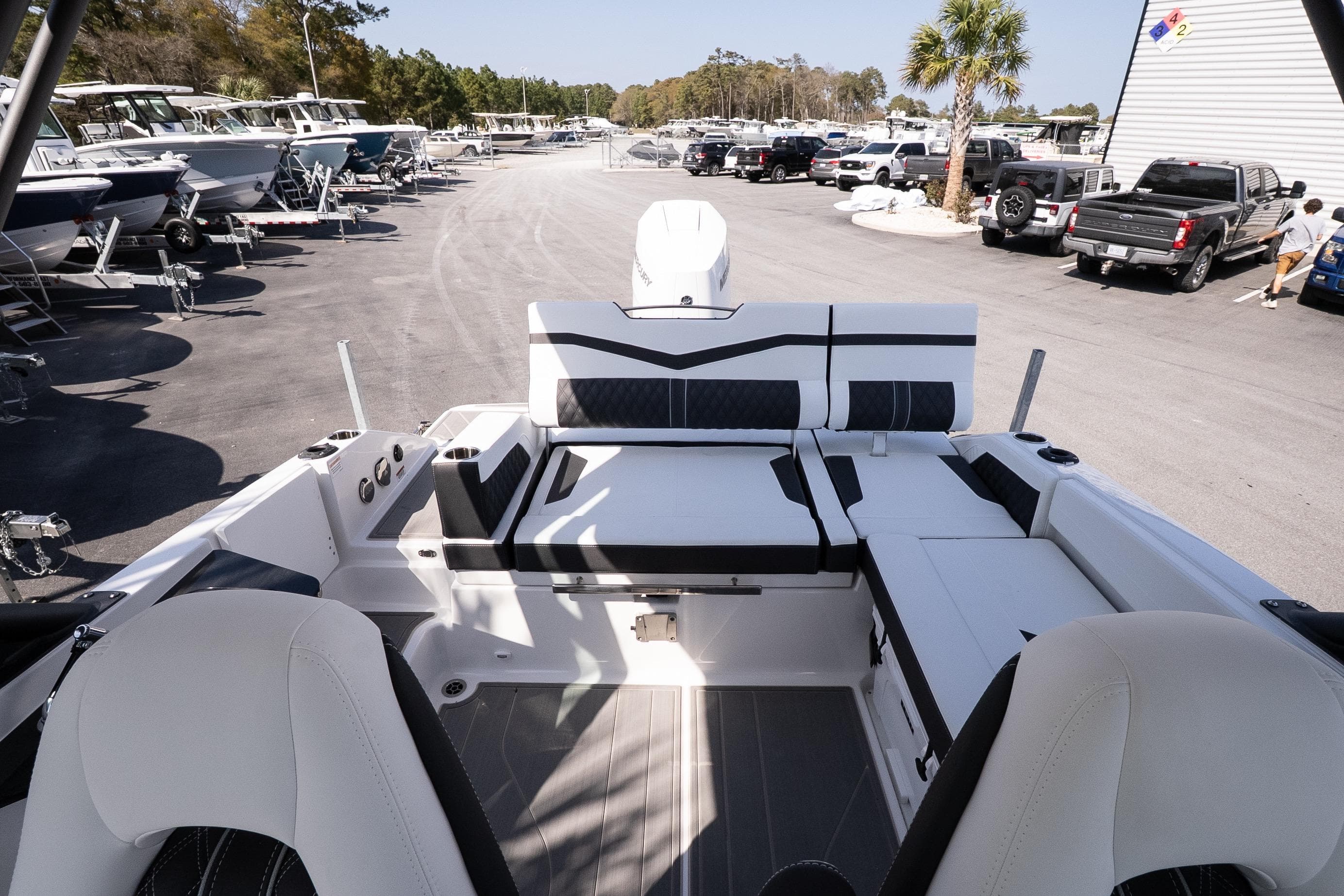 2026 Monterey Elite 27 OB boat interior with luxurious seating at a marina.