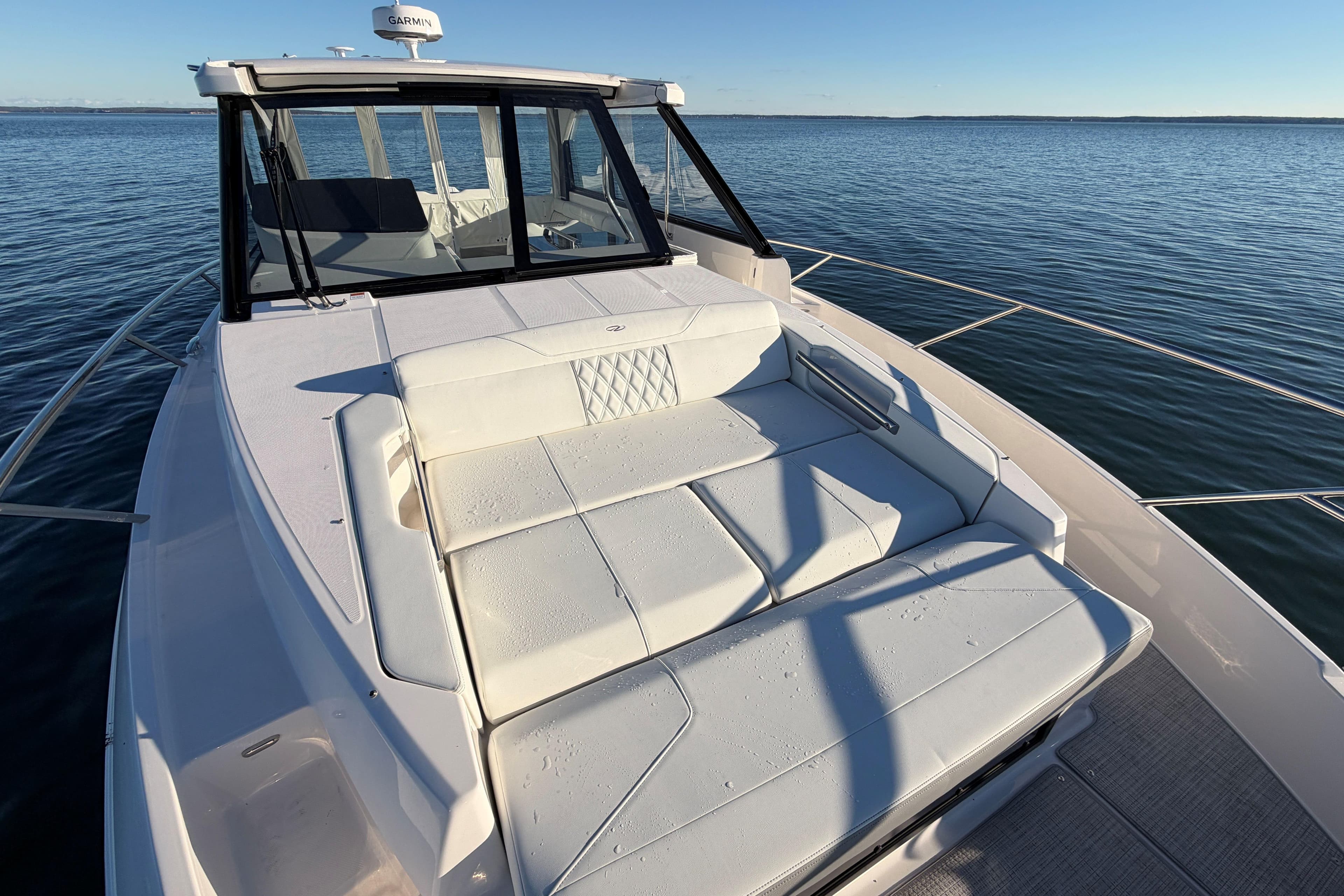 2026 Regal 36 XO yacht with spacious sun deck on calm waters.