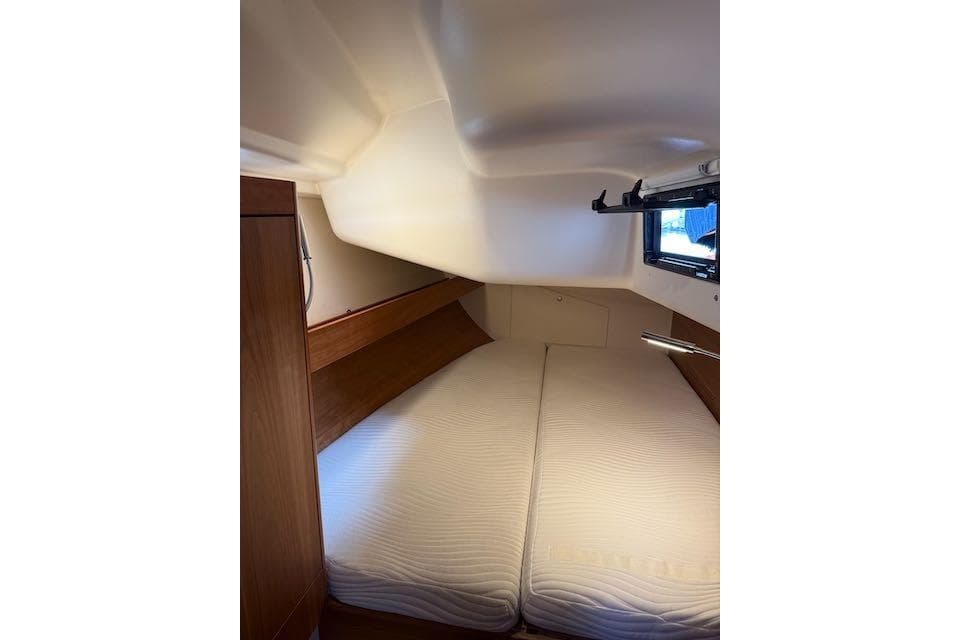Cozy cabin interior of 2017 Dehler 38 sailboat with twin beds and window.
