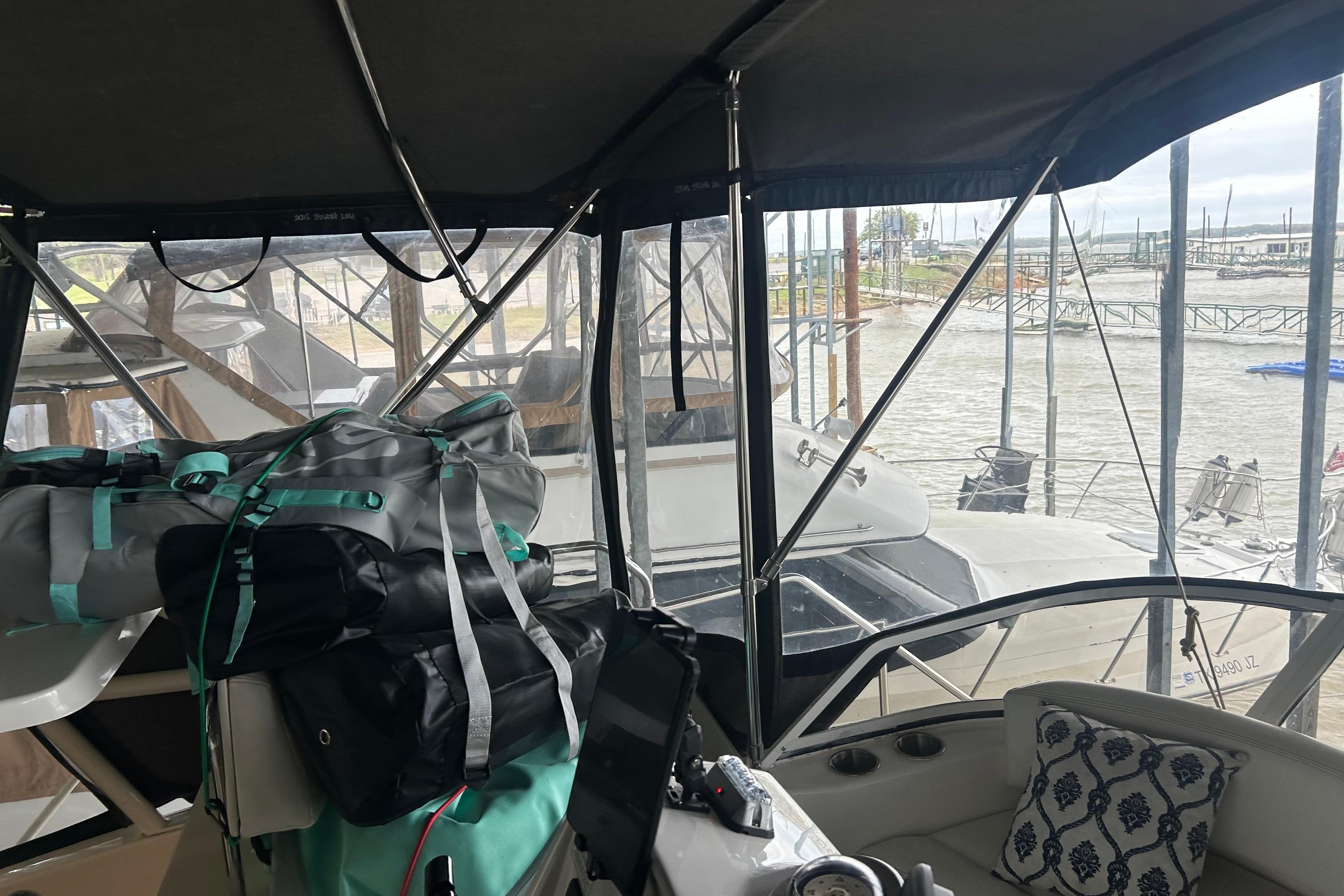 Interior view of a 1999 Silverton 352 Motor Yacht with bags and marina backdrop.