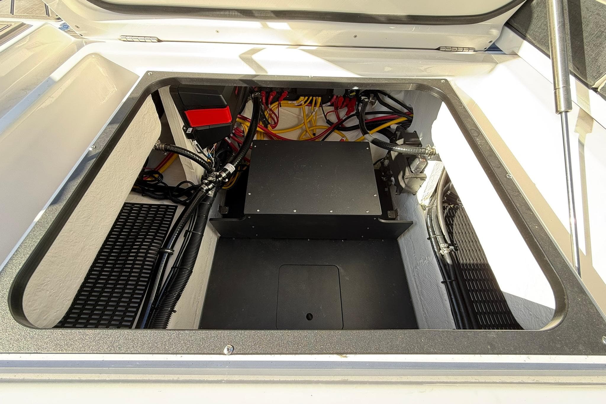 Open engine compartment of 2026 Monterey Elite 27 OB boat, showcasing wiring and components.