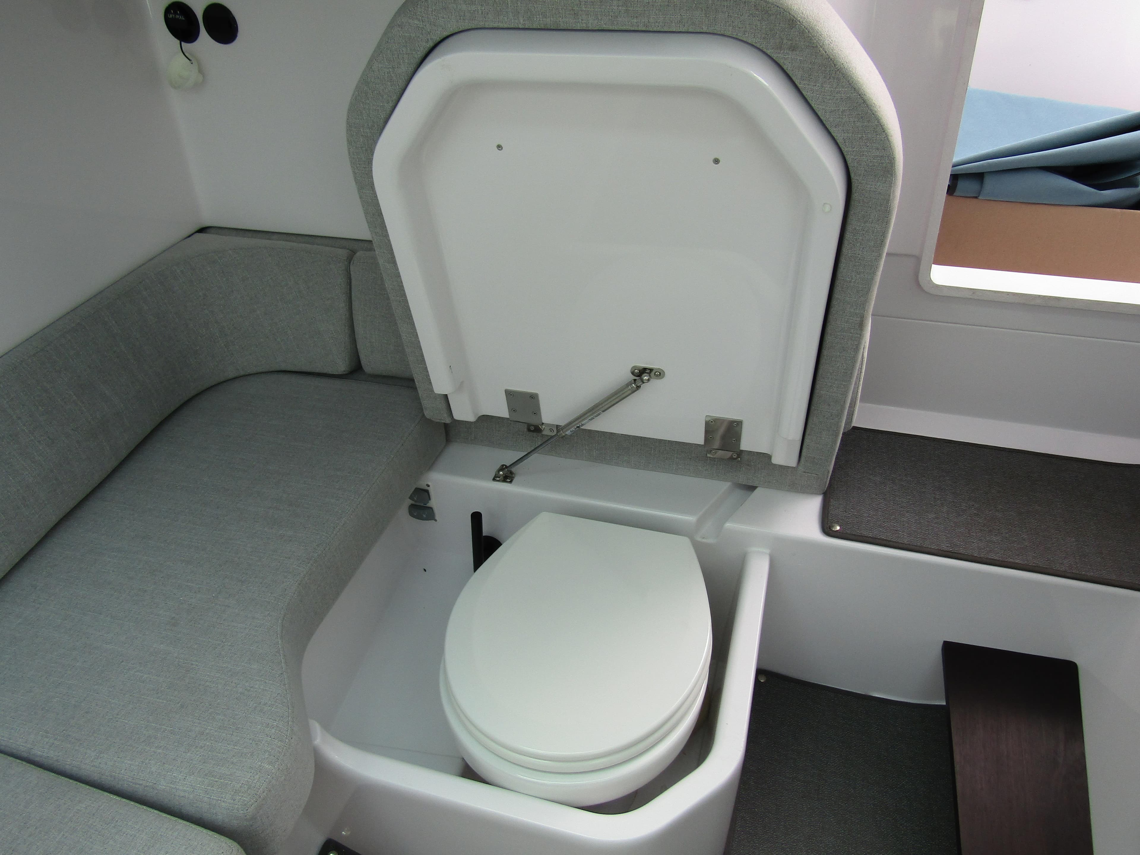 2024 Axopar 37 Sun Top interior with hidden toilet under seat.