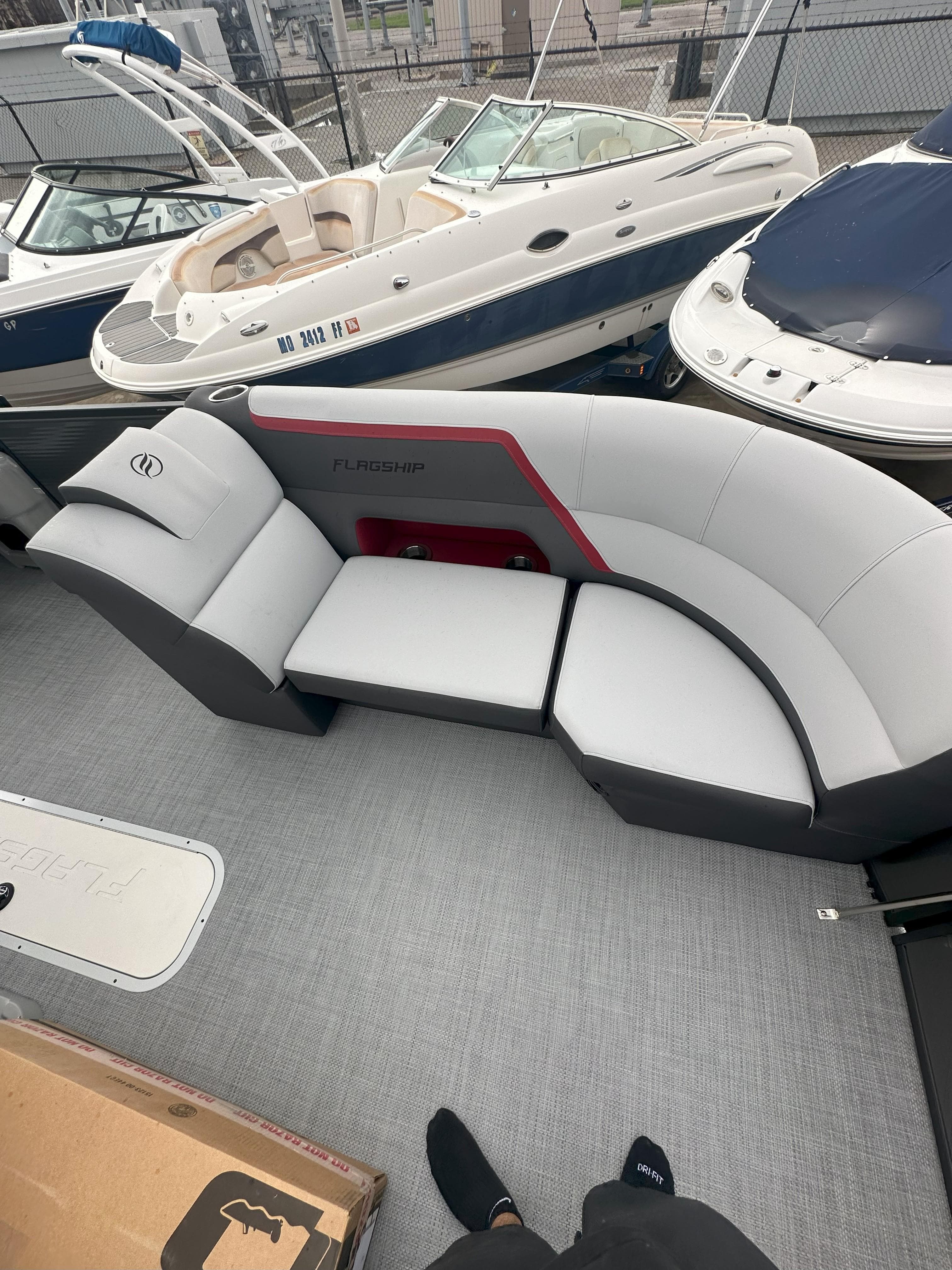 2026 Flagship D22CU Extended Deck with modern seating, docked among other boats.