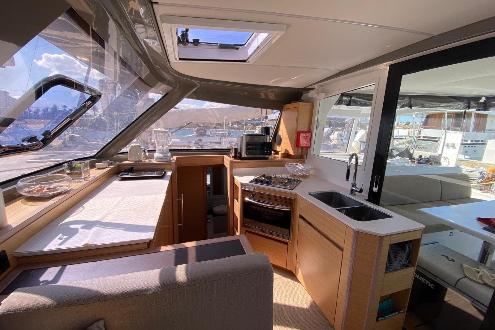 Modern kitchen interior of 2021 Nautitech 40 Open catamaran with panoramic windows.