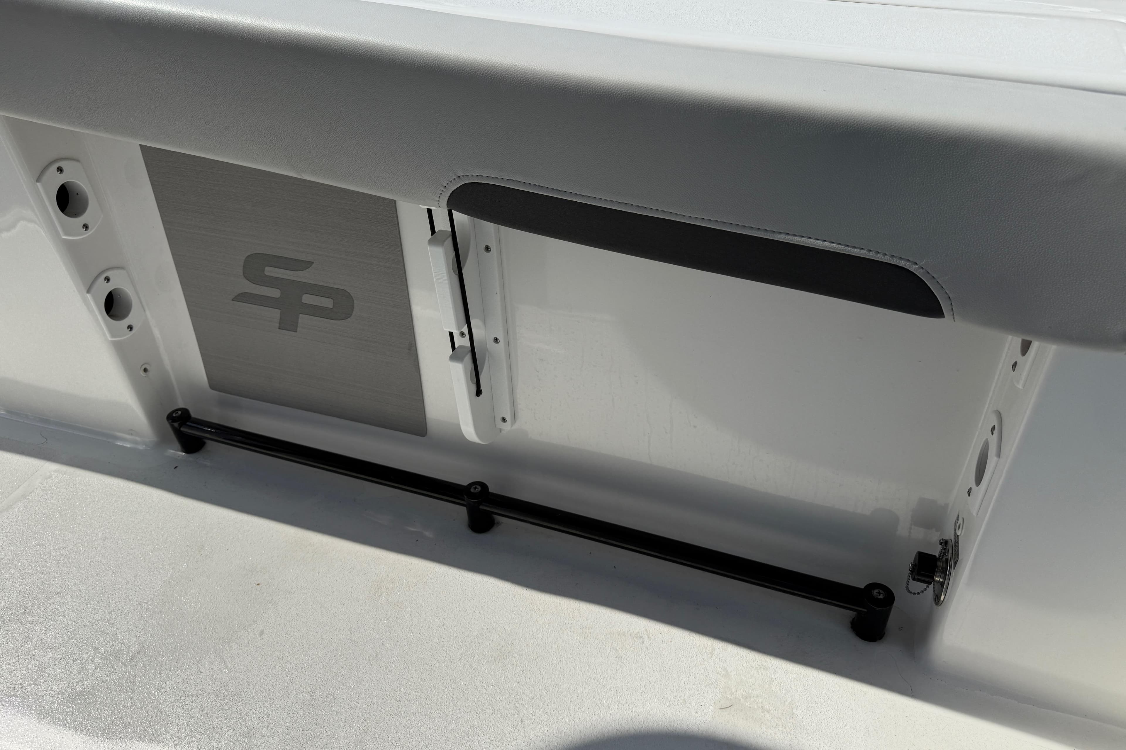 2025 Sea Pro 245FLX Sandbar boat interior detail with logo and storage compartment.