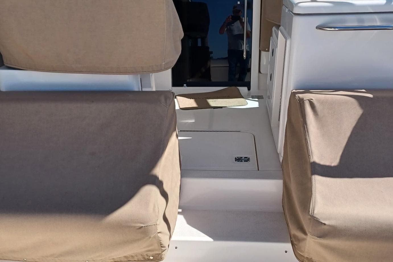 2001 Pursuit 3400 Express boat interior with beige seating and white deck.
